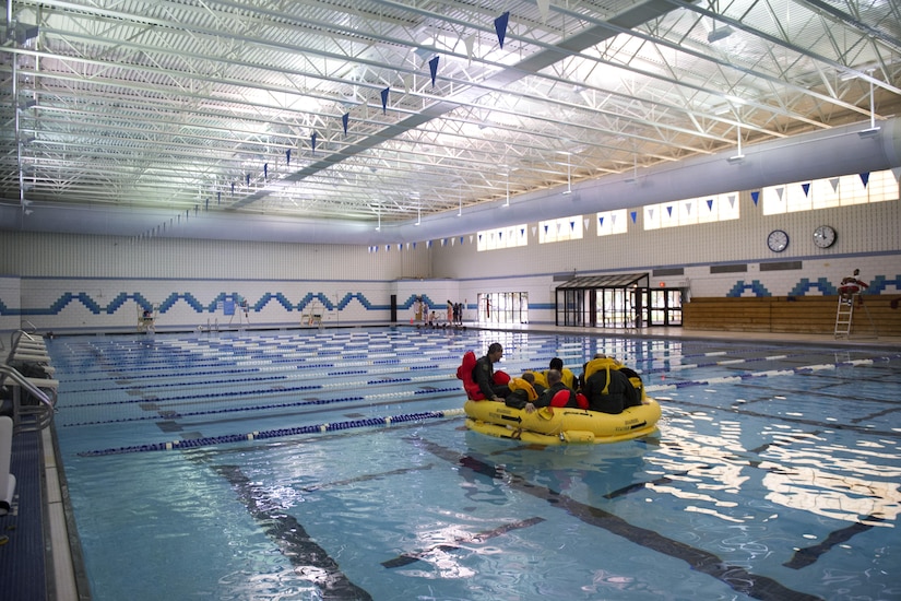 Flight crew members from the National Capital Region sit in a life raft during Water Survival Training with 89th Operations Support Squadron survival, evasion, resistance and escape specialists at Prince George’s Community College’s Robert I. Bickford Natatorium in Largo, Md., Oct. 27, 2016. The Water Survival Training equips these Airmen with the knowledge and confidence needed to survive in an open ocean environment using the equipment onboard their aircraft.  (U.S. Air Force photo by Senior Airman Philip Bryant)