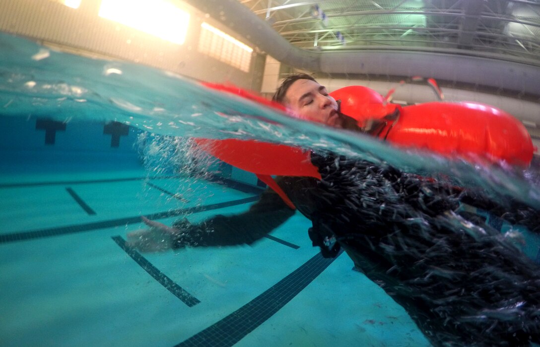 Lt. Col. Dave Fink, 1st Helicopter Squadron pilot, side-swims during Helicopter Emergency Egress Device Training at Prince George’s Community College’s Robert I. Bickford Natatorium in Largo, Md., Oct. 28, 2016. Aircrew from the 1st HS are required to go through the training every two years to ensure they stay up-to-date on flying requirements. (U.S. Air Force photo by Senior Airman Philip Bryant)