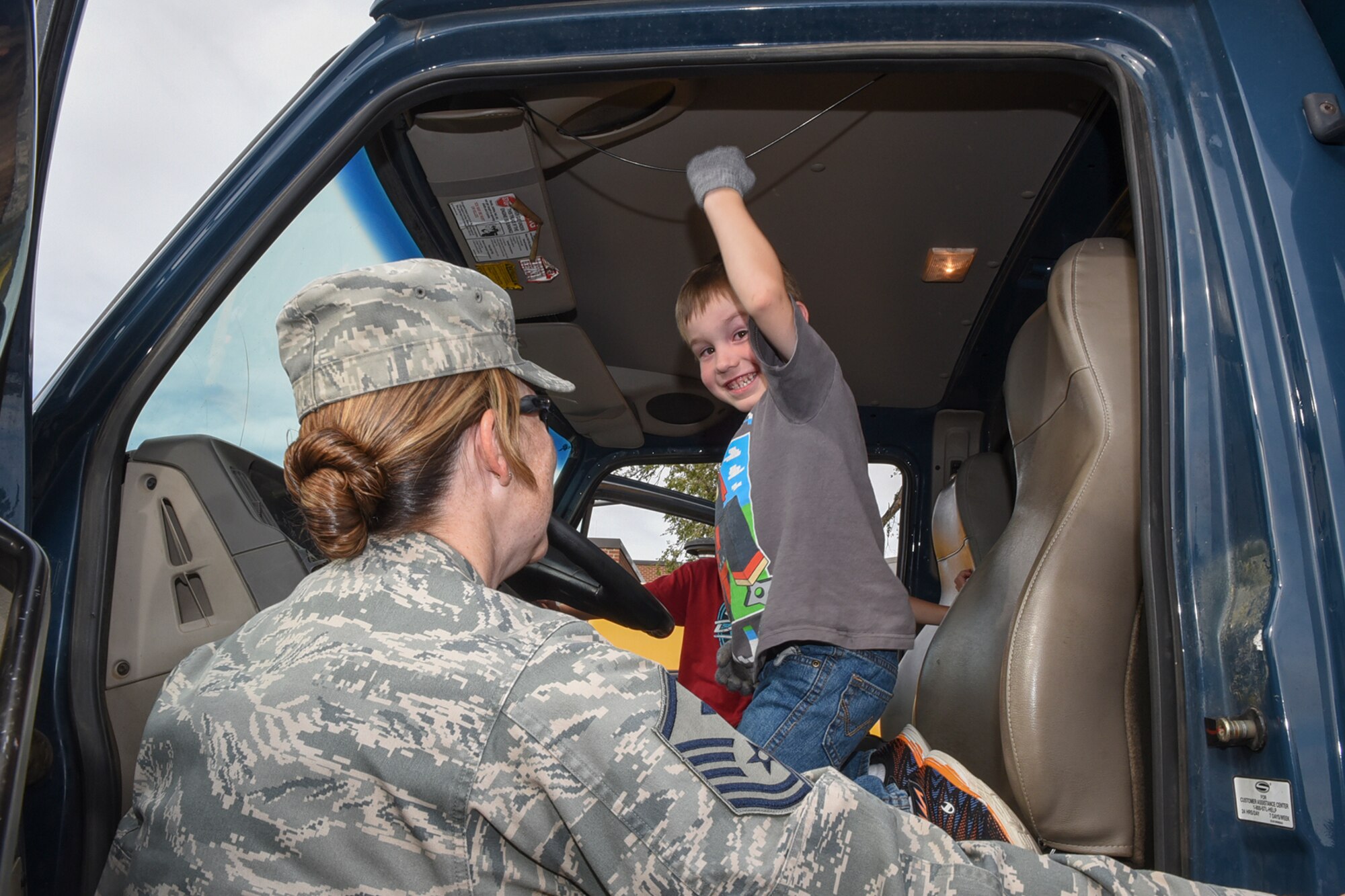As part of the annual snow parade, a boy from the R.P. Lee Youth Center, blows the horn of a snow plow at Peterson Air Force Base, Colo., Oct. 28, 2016. The parade traveled through the base, and stopped at the Child Development Center and Youth Center for the kids to see and explore the base’s snow equipment. (U.S. Air Force photo by Philip Carter)