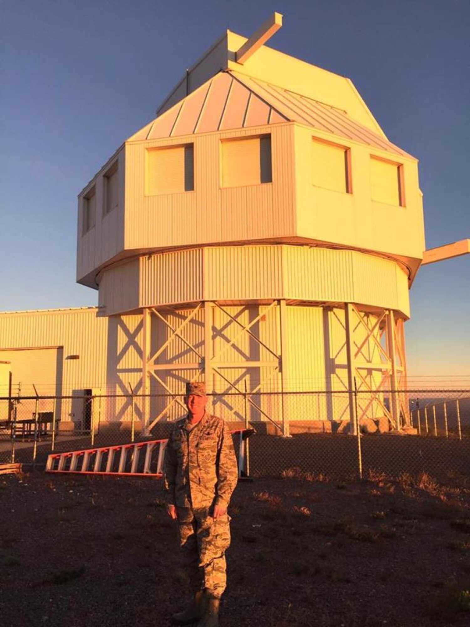 Col. Troy Endicott, 21st Operations Group commander, stands in front of the Space Surveillance Telescope as the sun sets at White Sands Missile Range, N.M., Oct 18, 2016. The SST brings many new capabilities to deep space observations, including an extra wide field-of-view and unrivaled speed. (Courtesy photo)