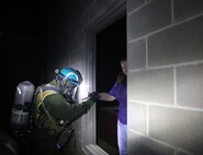 Cpl. Shawn Playford  a chemical biological radiological nuclear, CBRN, defense specialist with Identification and Detection platoon, Chemical Biological Incident Response Force, CBIRF, helps a simulated victim of radiation exposure due to a notional nuclear explosion to safety during 48-hour operations as part of Exercise Scarlet Response 2016 at Guardian Centers, Perry, Ga., Aug. 25, 2016. Official U.S. Marine Corps photo by Lance Cpl. Maverick S. Mejia