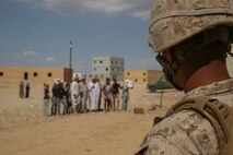 Corporal Christopher Ponce, a team leader with 3rd Battalion 7th Marine Regiment, stands at the corner of a building monitoring protesters during the battalion’s certification exercise aboard Marine Corps Air-Ground Combat Center Twentynine Palms, Calif., Aug. 22, 2016. U.S. Marine Corps photo by Cpl. Timothy Valero