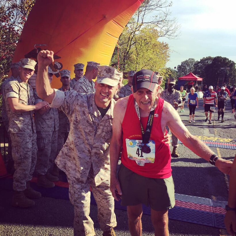 Retired Marine Col. Al Richmond, Groundpounder, finishes his 41st MCM!!!  Note his #41 race bib.
Col. Murray, Commander, MCINCR-MCB Quantico met Al at the finishline. 