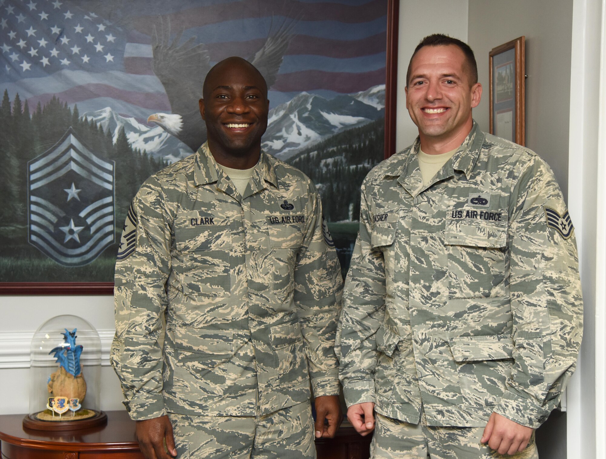 Chief Master Sgt. Vegas Clark, 81st Training Wing command chief, and Staff Sgt. Eric Dasher, 335th Training Squadron precision measurement and equipment laboratory basic course instructor, pose for a photo at the 81st TRW headquarters building Nov. 1, 2016, on Keesler Air Force Base, Miss. Dasher participated in the new Command Chief for a Day program which highlights outstanding enlisted performers from around the wing. Each Airman selected for the program will spend the day shadowing Clark to learn what it takes to be a command chief. (U.S. Air Force photo by Kemberly Groue/Released)