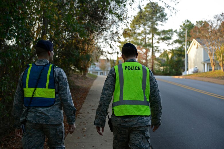 U.S. Air Force Senior Airman Barry O’Brien, 20th Security Forces Squadron installation patrolman, and Senior Airman Mitch Rabbitt, 20th SFS investigator, walk to their post during a Pumpkin Patrol event at Shaw Air Force Base, S.C., Oct. 31, 2016. Security Forces Airmen patrolled street corners and around base housing to ensure Team Shaw children could trick-or-treat safely. (U.S. Air Force photo by Airman 1st Class BrieAnna Stillman) 