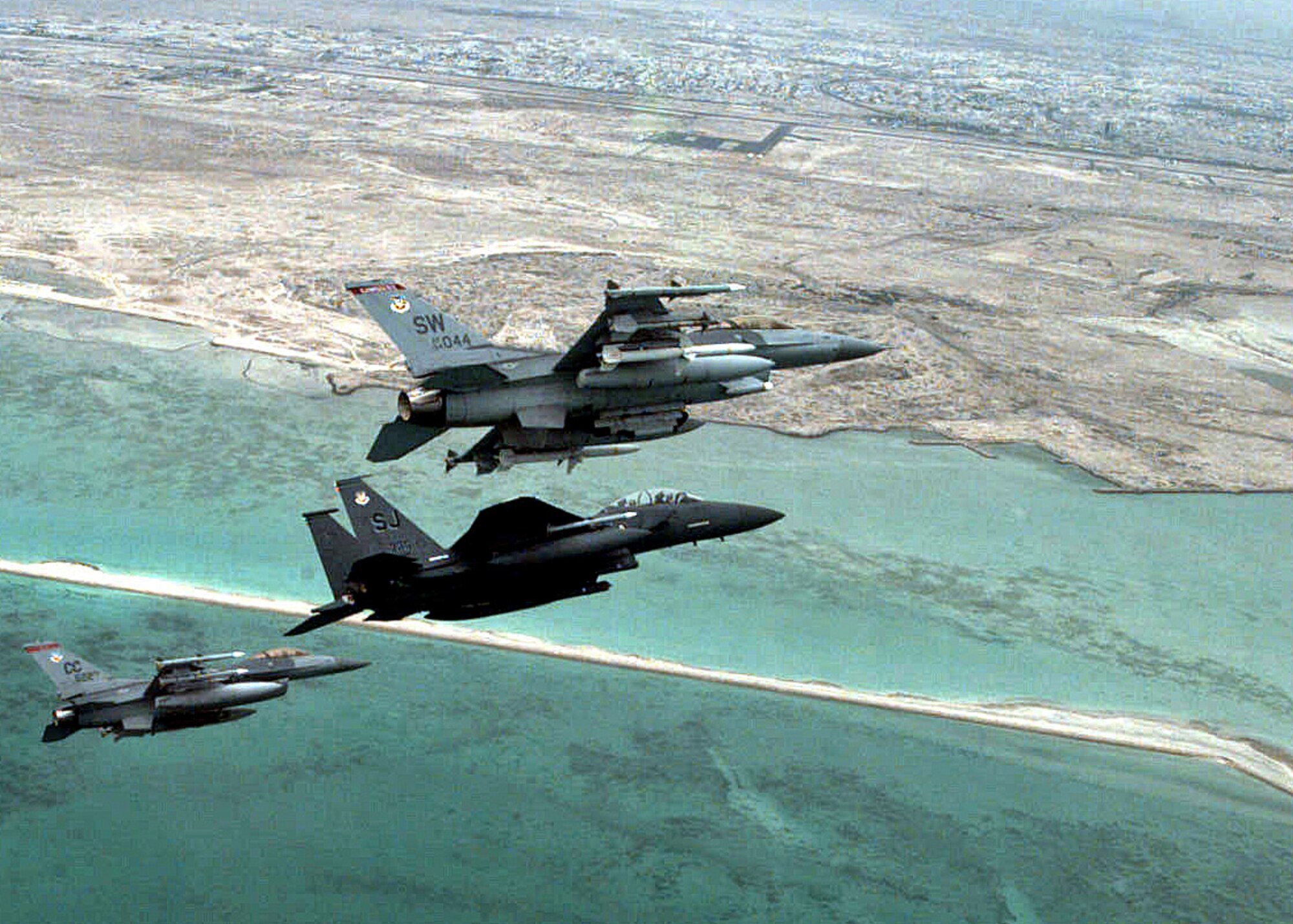 An F-16CM Fighting Falcon, right, assigned to 20th Fighter Wing, Shaw Air Force Base, S.C.; an F-15E Strike Eagle, center, 4th FW Seymour Johnson AFB, N.C.; and an F-16CJ Fighting Falcon, left, 27th FW, Cannon AFB, N.M., perform an aerial formation, June 2016. Today’s F-16s feature advanced aerospace systems based on those of past aircraft to include the F-15 and F-111 Aardvark. (Courtesy Photo)