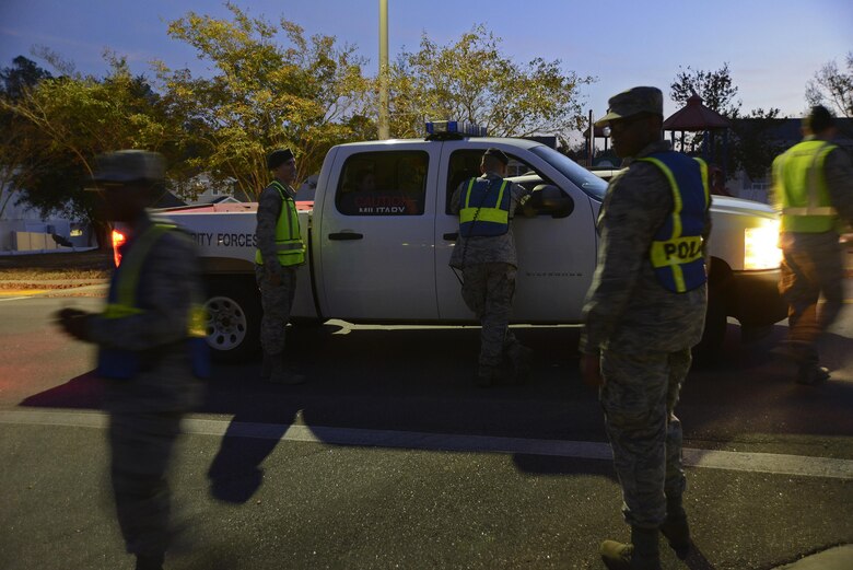 U.S. Airmen assigned to the 20th Fighter Wing communicate with each other, making sure the night is running smoothly during a Pumpkin Patrol event at Shaw Air Force Base, S.C., Oct. 31, 2016. Pumpkin Patrol was intended to make sure all trick-or-treaters were safe during Halloween night. (U.S. Air Force photo by Airman 1st Class BrieAnna Stillman)