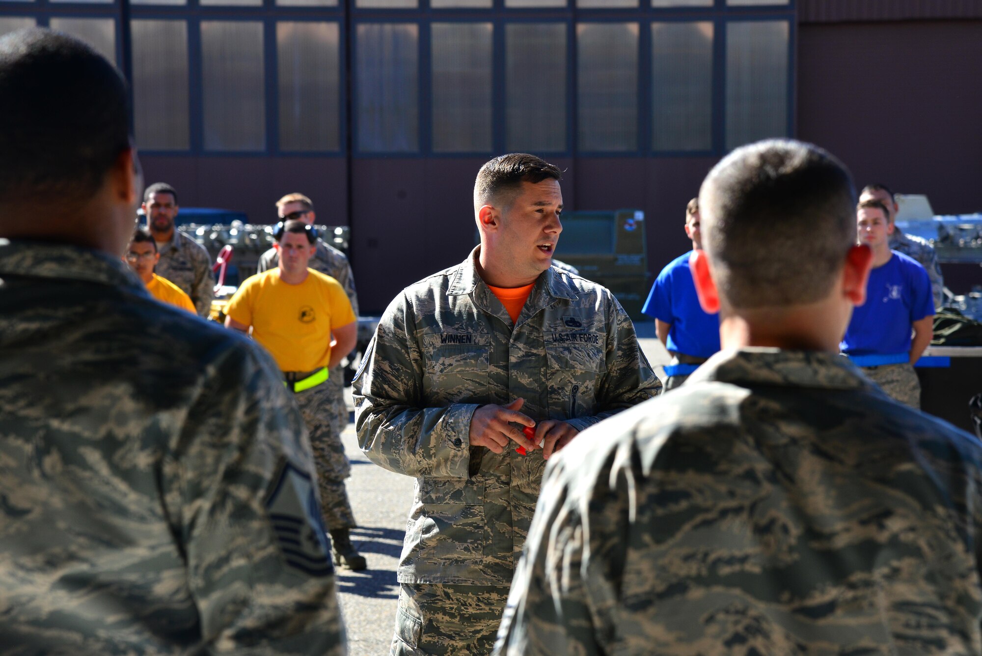 U.S. Air Force Master Sgt. Theodore Winnen, 1st Maintenance Group weapons standardization superintendent, welcomes the audience to the 1st Maintenance Squadron Weapons Load Crew of the Quarter competition at Joint Base Langley-Eustis, Va., Oct. 28, 2016. The competition is held every quarter and allows the load crews from each aircraft maintenance unit to showcase their skills and abilities while loading the aircraft with munitions. (U.S. Air Force photo by Airman 1st Class Tristan Biese)