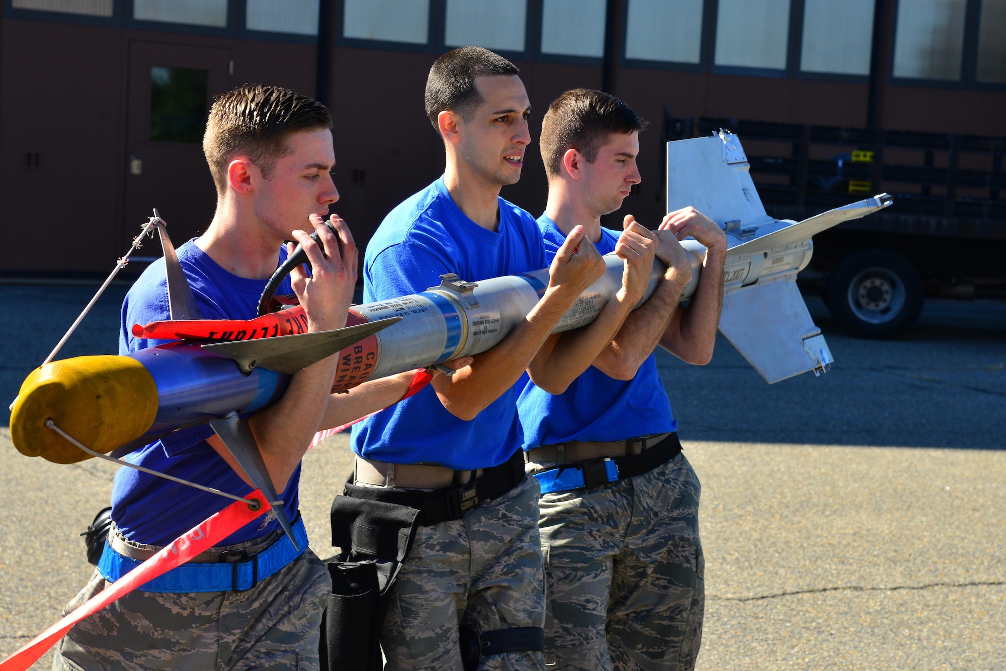 U.S. Air Force Airmen from the 94th Aircraft Maintenance Unit, carry munitions to an F-22 Raptor during the 1st Maintenance Squadron Weapons Load Crew of the Quarter competition at Joint Base Langley-Eustis, Va., Oct. 28, 2016. 1st Maintenance Group maintainers are responsible for worldwide rapid deployment and employment of combat-ready and mission-capable F-22s. (U.S. Air Force photo by Airman 1st Class Tristan Biese)
