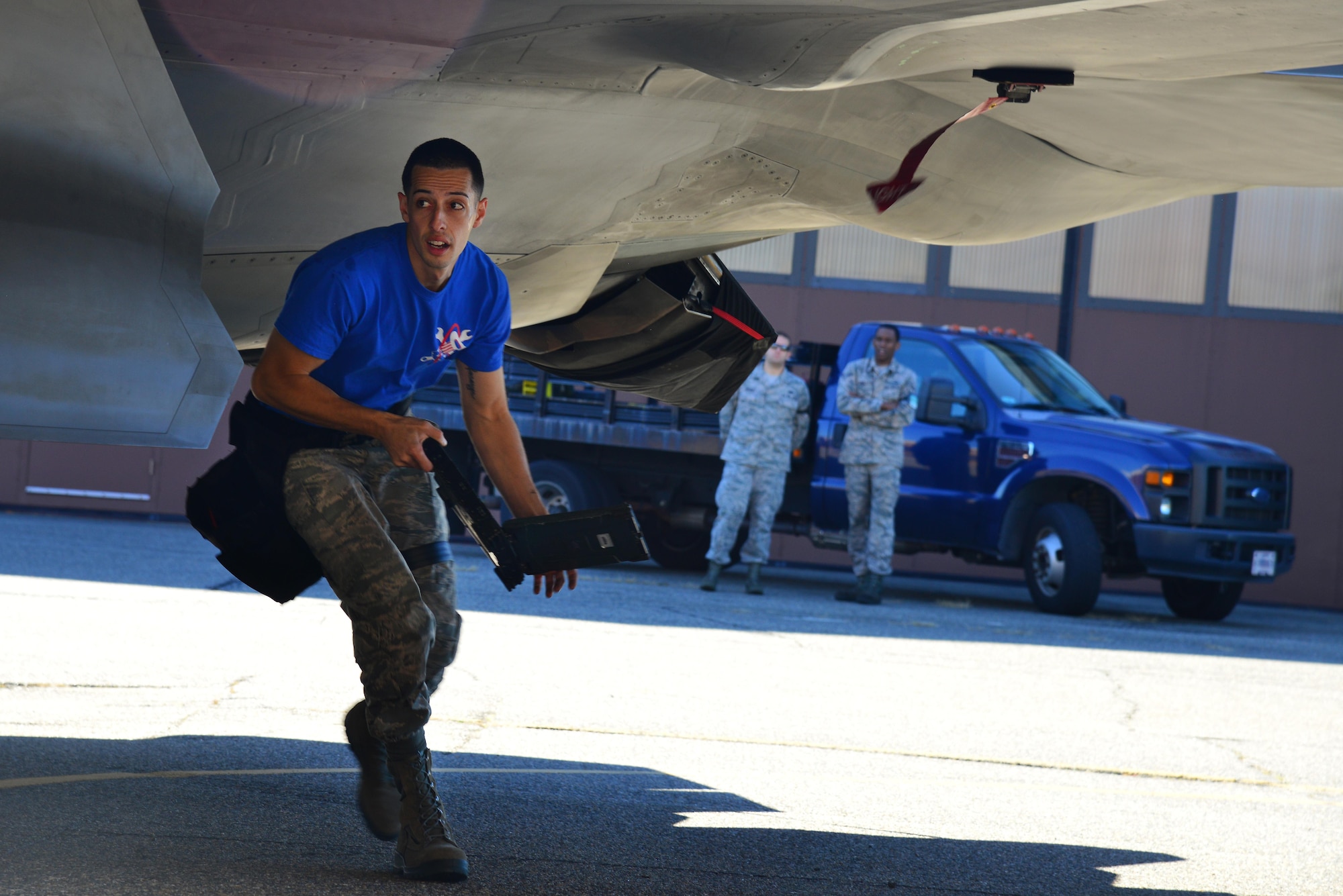 U.S. Air Force Staff Sgt. Alex Ponzi, 94th Aircraft Maintenance Unit weapons load crew chief, competes during the 1st Maintenance Squadron Weapons Load Crew of the Quarter competition at Joint Base Langley-Eustis, Va., Oct. 28, 2016. Weapons load crews worked in three-person teams to inspect and load munitions onto aircraft in a timely and accurate manner. (U.S. Air Force photo by Airman 1st Class Tristan Biese)
