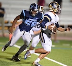 Alex Brown (left), a 6-foot-2-inch, 220-pound defensive end for the Claudia “Lady Bird” Johnson High School Jaguars in San Antonio, chases down O’Connor High School Panthers quarterback Roel Sanchez Sept. 17 on his way to a quarterback sack. Alex attributes the sacrifices of his parents and having the support of his teammates support as motivation for him to succeed on and off the field.