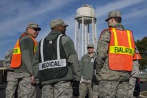 Team Dover Wing Inspection Team members discuss their evaluations during the annual Force Protection and Major Accident Response Exercise Oct. 26, 2016, near the south gate at Dover Air Force Base, Del. WIT members from every unit assigned to the 436th Airlift Wing, who participated in the event as subject matter experts, identified strengths, weaknesses and areas of improvement based on exercise performance. (U.S. Air Force photo by Senior Airman Aaron J. Jenne)