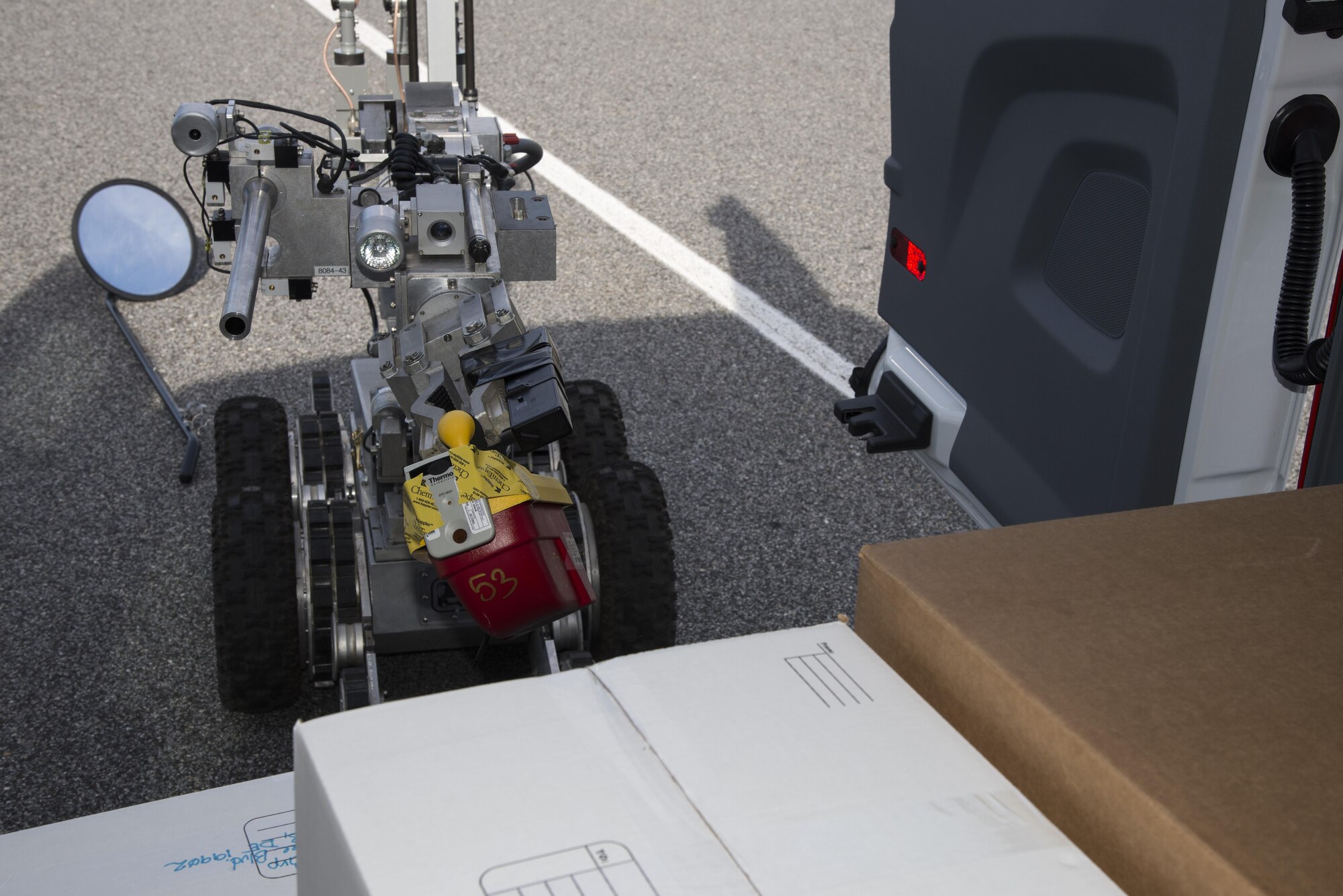 An F-6 explosive ordnance disposal robot, operated by members of the 436th Civil Engineer Squadron, inspects a simulated suspected vehicle-borne radiological device. While the 436th CES EOD operated the robot to measure radiation levels, members of the 436th Aerospace Medical Squadron Bioenvironmental Engineering flight monitored the instrument readings for radiation. (U.S. Air Force photo by Senior Airman Aaron J. Jenne)
