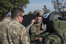 Staff Sgt. William Spencer, 436th Civil Engineer Squadron explosive ordnance disposal journeyman, coordinates the EOD investigation of a simulated suspected vehicle borne radiological device Oct. 26, 2016, at the south gate on Dover Air Force Base, Del. Airmen participating in the exercise were evaluated on procedural knowledge and adherence as well as teamwork and effectiveness. (U.S. Air Force photo by Senior Airman Aaron J. Jenne)
