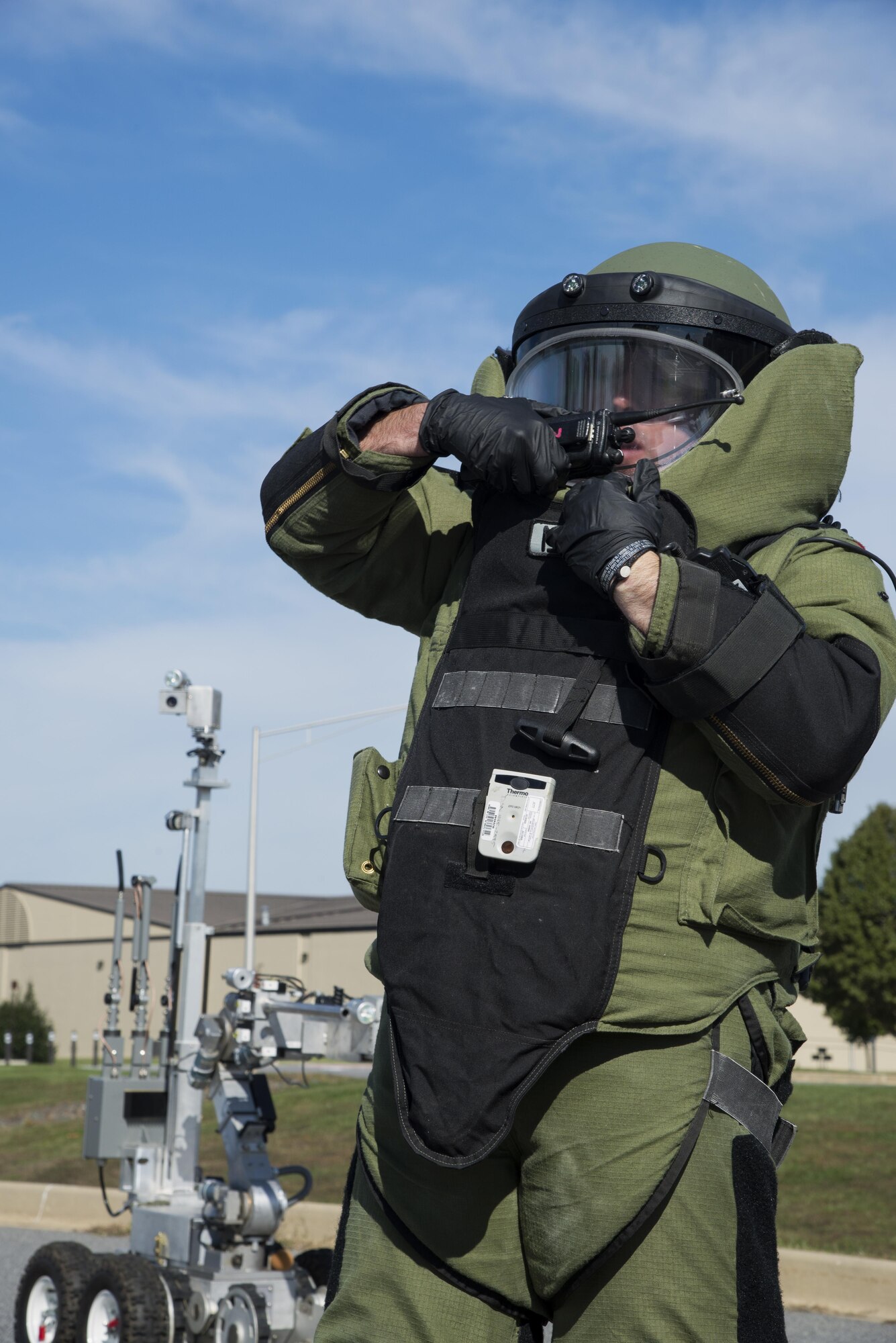 Staff Sgt. J. J. Hargrove, 436th Civil Engineer Squadron explosive ordnance disposal journeyman, notifies the incident commander of simulated findings at a suspected vehicle-borne radiological device Oct. 26, at the south gate of Dover Air Force Base, Del. In the scenario, Hargrove received harmful amounts of radiation due to faulty instrument data, necessitating decontamination and medical evaluation. (U.S. Air Force photo by Senior Airman Aaron J. Jenne)
