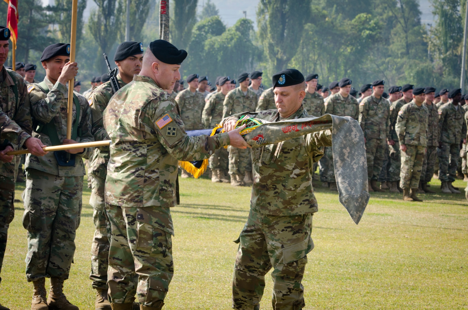 Col. Timothy Hayden (left) and Command Sgt. Maj. Dale Sump (right), the commander and command sergeant major of the 1st Armored Brigade Combat Team, 1st Infantry Division, respectively, uncase the brigade's colors during a transfer of authority ceremony on Indianhead Field, Oct. 28, 2016.  During the ceremony, the brigade officially took charge of the rotational mission on the Korean peninsula from the 1st ABCT, 1st Cavalry Division. 