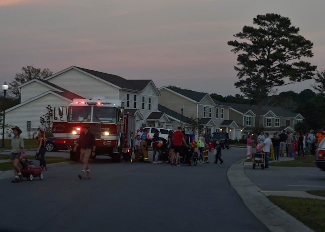 Members of the 628th Civil Engineer Squadron hand out candy during Pumpkin Patrol here, Oct. 31, 2016. On Halloween, members of Joint Base Charleston volunteered for Pumpkin Patrol to walk through base housing on the lookout for injured or lost children.