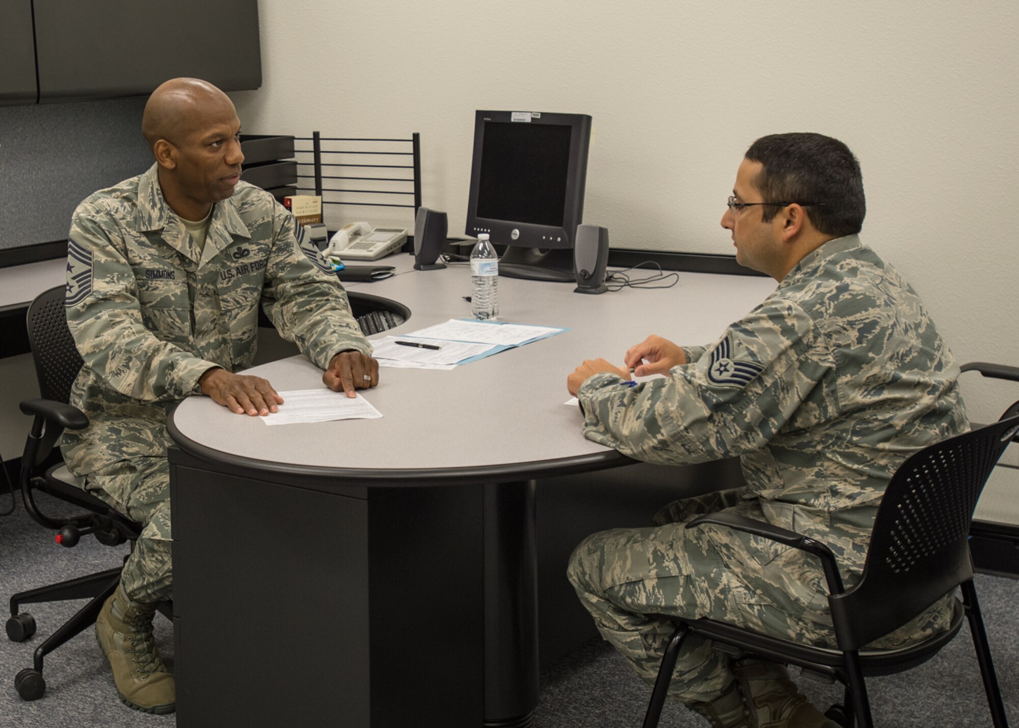 Chief Master Sgt. Todd Simmons (left), 412th Test Wing command chief, talks with Staff Sgt. Noah Clifton, 31st Test and Evaluation Squadron, at the Desert Mall Oct. 21. The chief led a team of chief master sergeants during the Chief Speed Review. Fifty Airmen rotated through five chiefs for five minutes each to receive career guidance and discuss future opportunities within the Air Force. (U.S. Air Force photo by John Perry) 