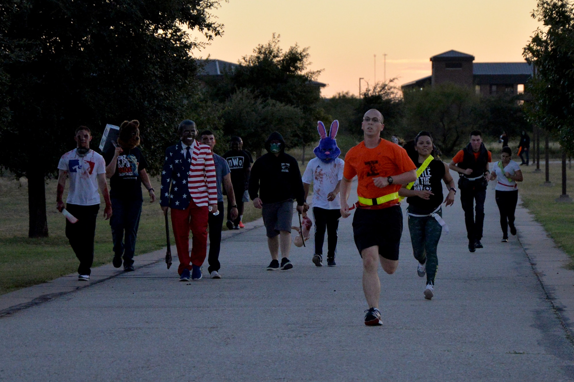 Participants of the purge 5k run from volunteers in costumes during Ghoulfellow on Goodfellow Air Force Base, Texas, Oct. 28, 2016. The purge 5k featured “adversaries” who attempted to grab flags on each runner. (U.S. Air Force photo by Airman 1st Class Randall Moose/Released)