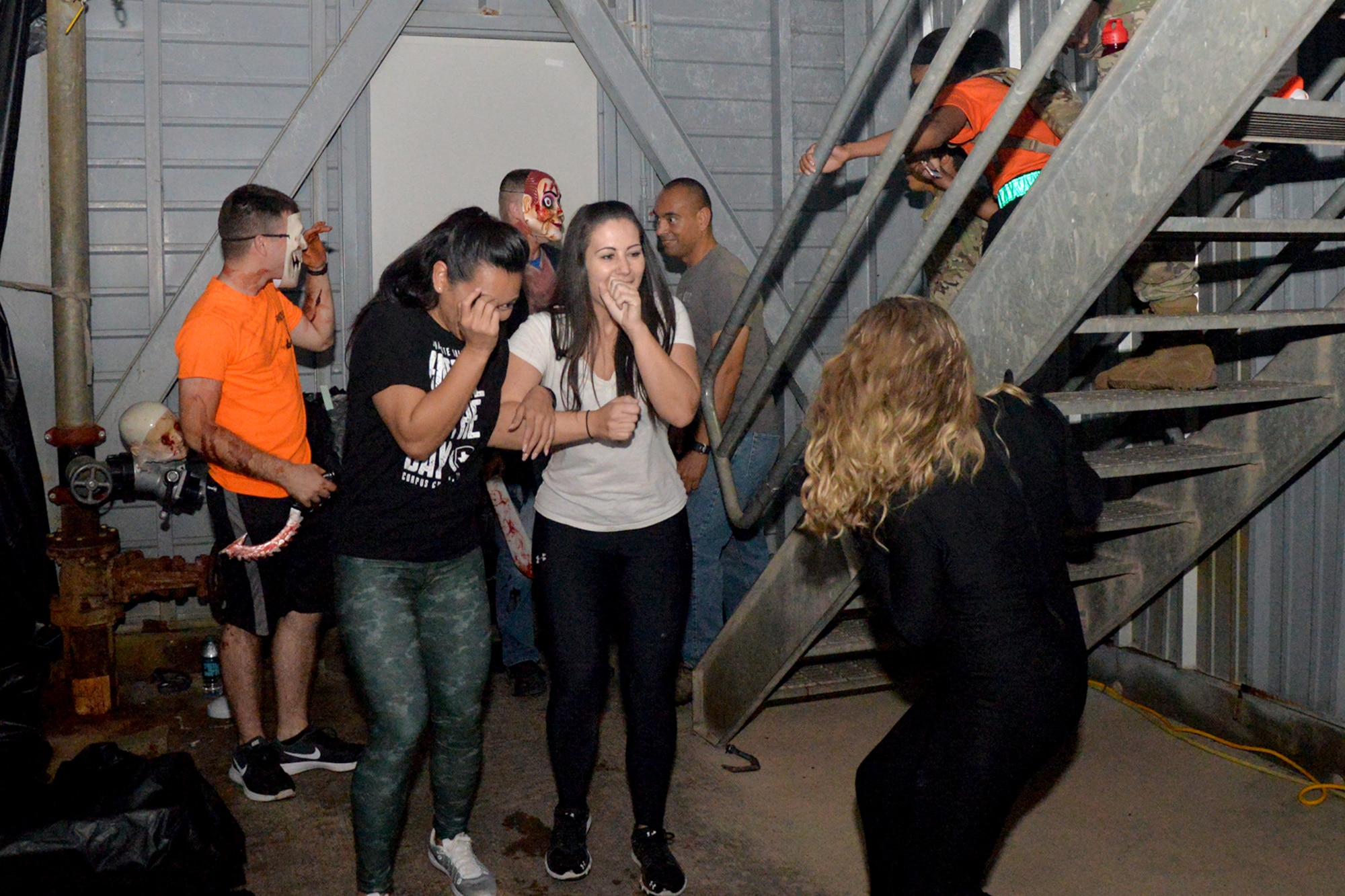 Volunteers scare participants in the haunted house at the Louis F. Garland Department of Defense Fire Academy training pad during Ghoulfellow on Goodfellow Air Force Base, Texas, Oct. 28, 2016. Volunteers from various squadrons on base dressed up in costumes to play roles in the haunted house. (U.S. Air Force photo by Airman 1st Class Randall Moose/Released)