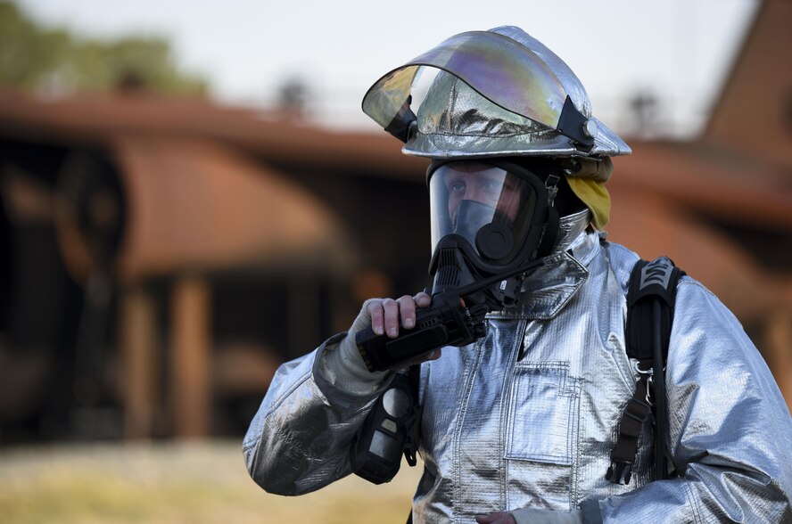 Master Sgt. Zachary McKinney, 2nd Civil Engineer Squadron assistant fire chief of training, communicates with the Airmen working in the control tower during an aircraft live fire burn at Barksdale Air Force Base, La., Oct. 26, 2016. McKinney was the instructor while the crews went out to combat the fires. (U.S. Air Force photo/Airman 1st Class Stuart Bright)