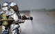 A 2nd Civil Engineer firefighter fires up his hose during an aircraft live fire burn at Barksdale Air Force Base, La., Oct. 26, 2016. The aircraft live fire burn training happens once every six months (U.S. Air Force photo/Airman 1st Class Stuart Bright)