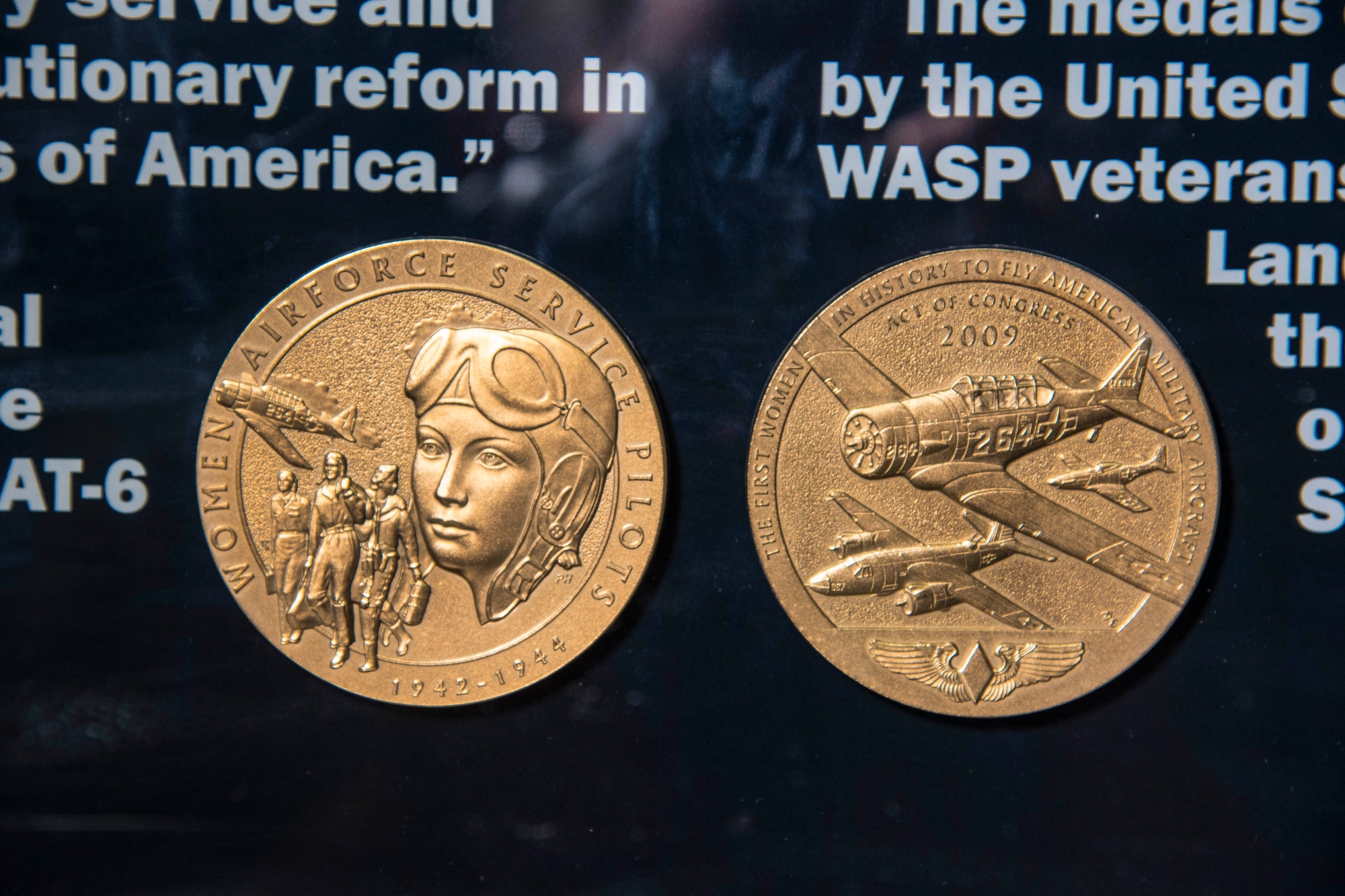 DAYTON, Ohio -- On July 1, 2009, President Barack Obama authorized Public Law 111-40 awarding the Congressional Gold Medal-the highest civilian recognition that Congress can bestow-to the Women Airforce Service Pilots(WASP). The 111th Congress awarded the medal "In recognition of their pioneering military service and exemplary record, which forged revolutionary reform in the Armed Forces of the United States of America." The medals on display are bronze replicas made by the U.S. Mint. They were presented to WASP veterans Marie Barrett Marsh and Genevieve Landman Rausch in 2010, and donated to the Museum on their behalf in 2015. The original WASP gold medal is kept by the Smithsonian Institution. (U.S. Air Force photo by Ken LaRock)