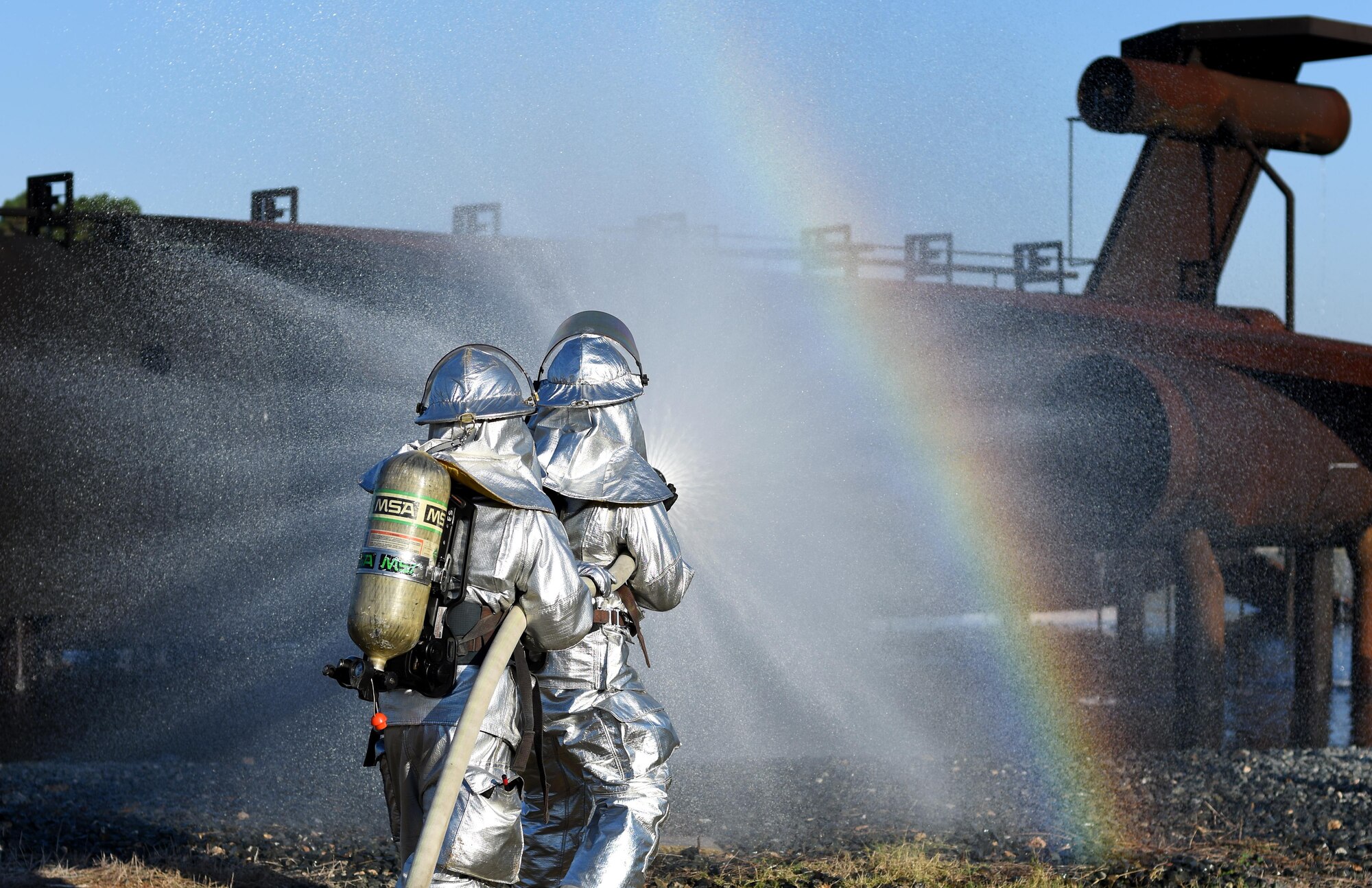 Firefighters from the 2nd Civil Engineer Squadron extinguish a fire during an aircraft live fire burn on Barksdale Air Force Base, La., Oct. 27, 2016. Aircraft live fire burns are done once every six months. (U.S. Air Force photo/Airman Alexis C. Schultz)