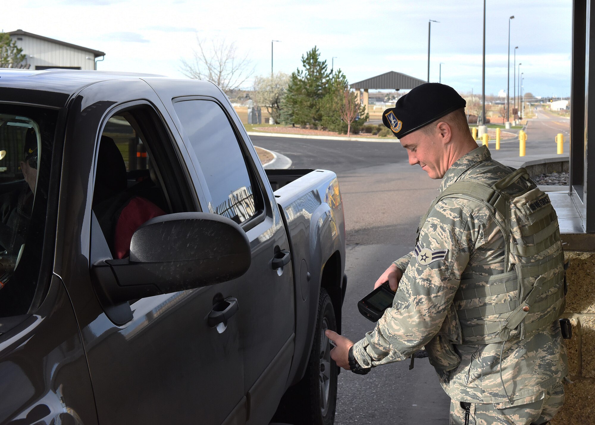 Airman 1st Class Dylan Kerns, 341st Security Forces Squadron member, checks identification cards for incoming visitors through the 10th Avenue North Access Gate at Malmstrom Air Force Base, Mont., Nov. 1, 2016.  The gate will serve as the permanent 24-hour main access gate starting on Nov. 5. (U.S. Air Force photo/Jason Heavner)