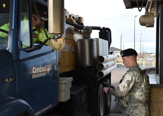 Airman 1st Class Dylan Kerns, 341st Security Forces Squadron member, checks identification cards for incoming visitors through the 10th Avenue North Access Gate at Malmstrom Air Force Base, Mont., Nov. 1, 2016.  The gate will serve as the permanent 24-hour main access gate starting on Nov. 5. (U.S. Air Force photo/Jason Heavner)