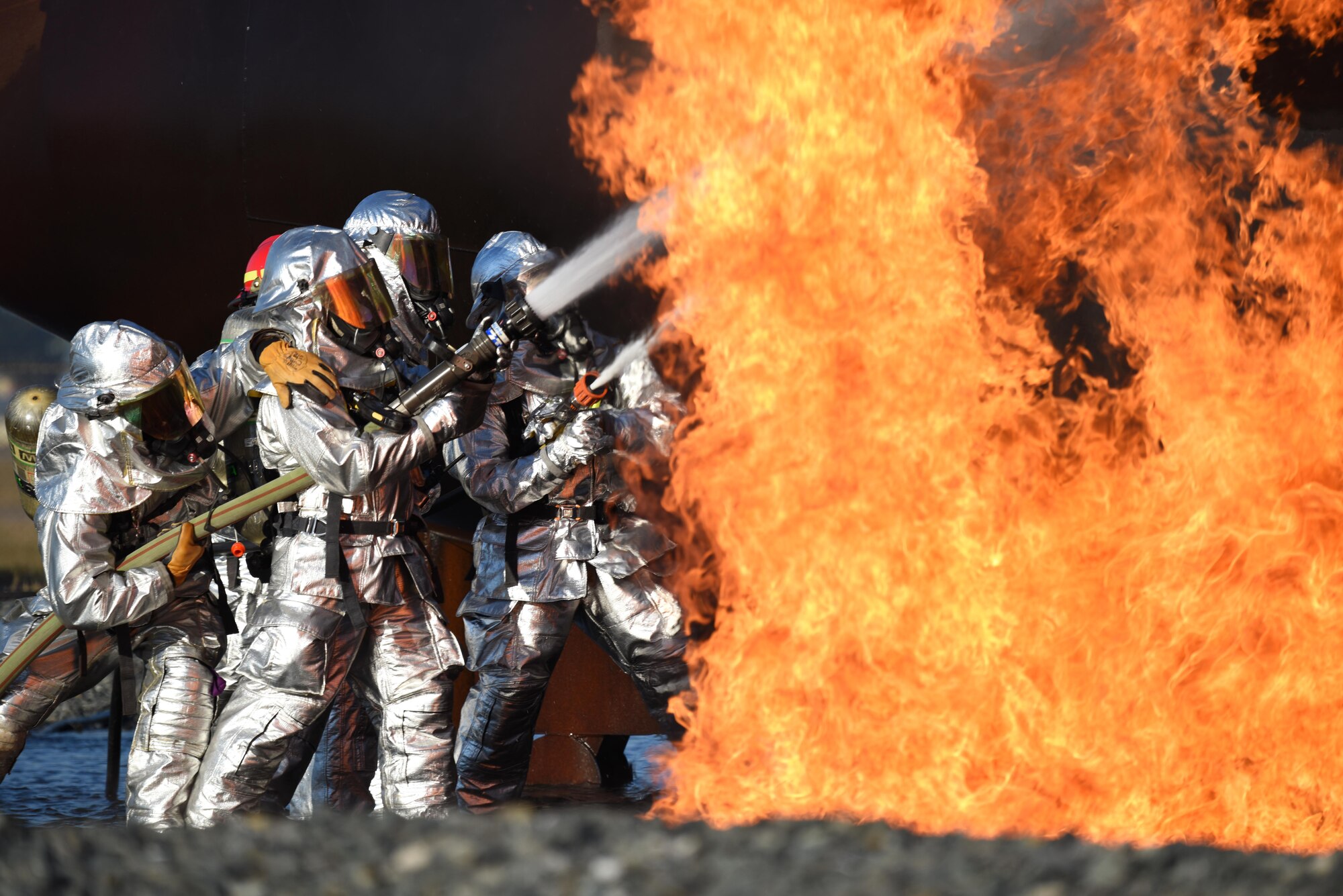 Firefighters from the 2nd Civil Engineer Squadron extinguish a fire during an aircraft live fire burn on Barksdale Air Force Base, La., Oct. 27, 2016. Aircraft live fire burns are done once every six months. (U.S. Air Force photo/Airman Alexis C. Schultz)