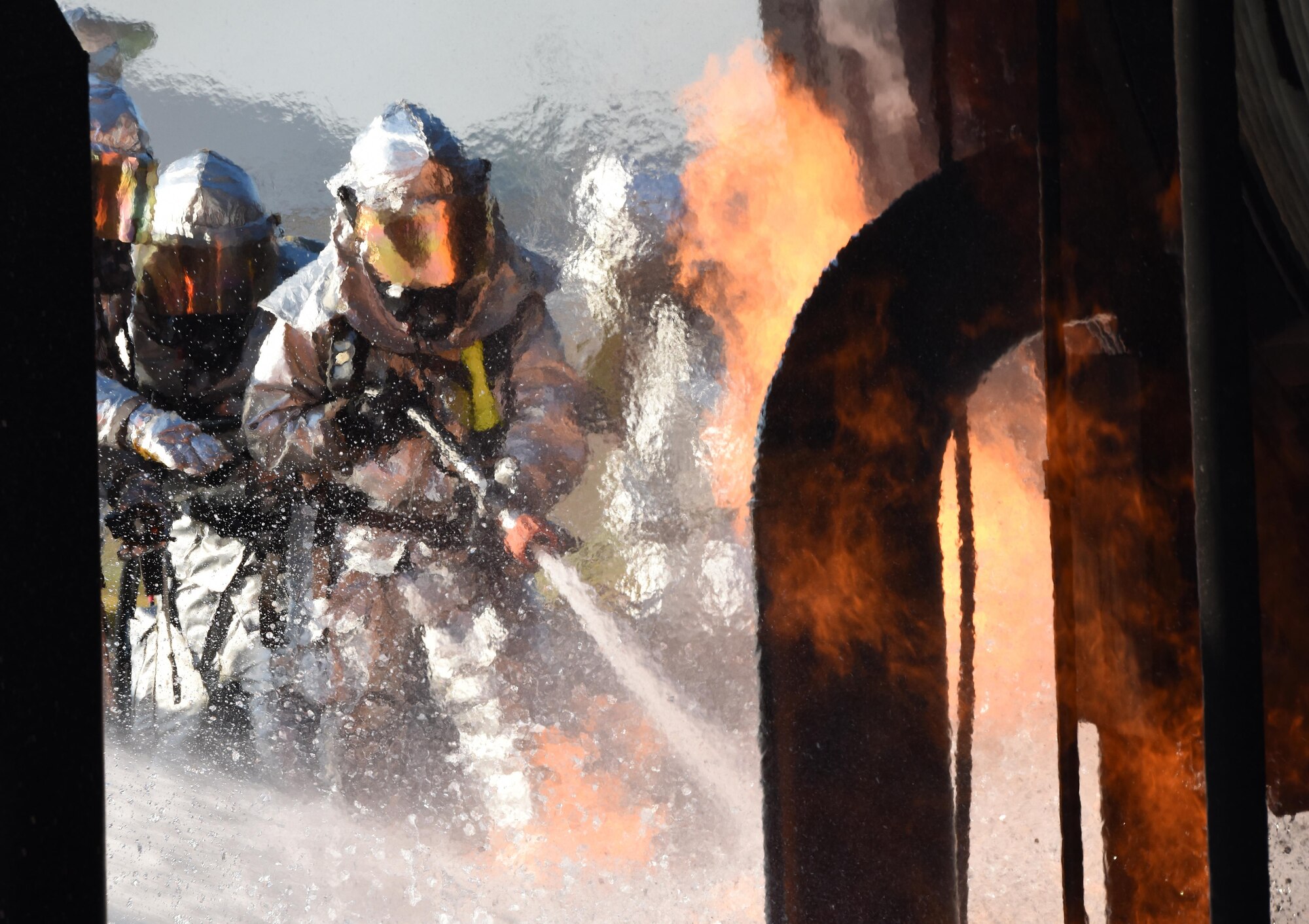 Firefighters from the 2nd Civil Engineer Squadron extinguish a fire during an aircraft live fire burn on Barksdale Air Force Base, La., Oct. 27, 2016. Aircraft live fire burns are done once every six months. (U.S. Air Force photo/Airman Alexis C. Schultz)