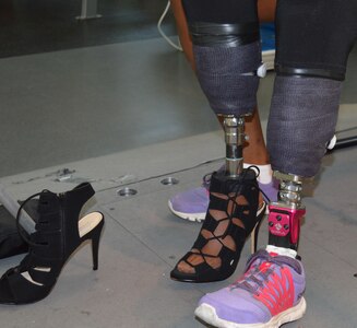 U.S. Army Spc. Cherdale Allen, a patient going through rehabilitation at the Center for the Intrepid, Brooke Army Medical Center, Fort Sam Houston, Texas, lost part of her left leg below the knee to cancer. She is overcoming the challenges and adjusting to getting back into her ‘heels’ using a prosthesis still in the test socket phase. This prosthesis is one of three Allen uses for walking, running and stepping out in style. (U.S. Army photo by Robert A. Whetstone/Released)