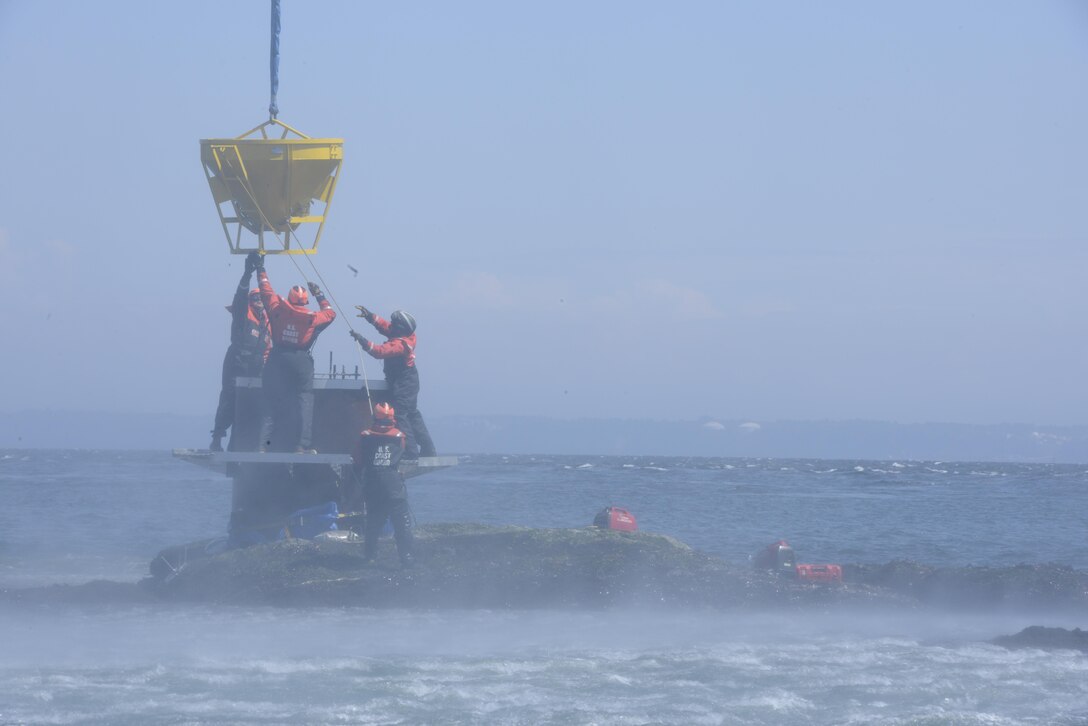 As new challenges arise associated with increasing maritime commerce, the
Coast Guard will continue to promote a safe, efficient and resilient Marine
Transportation System. Coast Guard members from Aids to Navigation Team
Puget Sound, in Seattle, and the Coast Guard Cutter Henry Blake, homeported
in Everett, Wash., work together to align a bucket full of concrete
suspended from a Coast Guard Air Station Astoria MH-60 Jayhawk helicopter
over the Ewing Island Reef in Washington. The concrete creates a foundation
for a reconstructed Ewing Island Danger Daybeacon, which will replace the
floating aid to navigation known as the Ewing Island Reef Danger Buoy.
(U.S. Coast Guard photo by Petty Officer 3rd Class Amanda Norcross)
