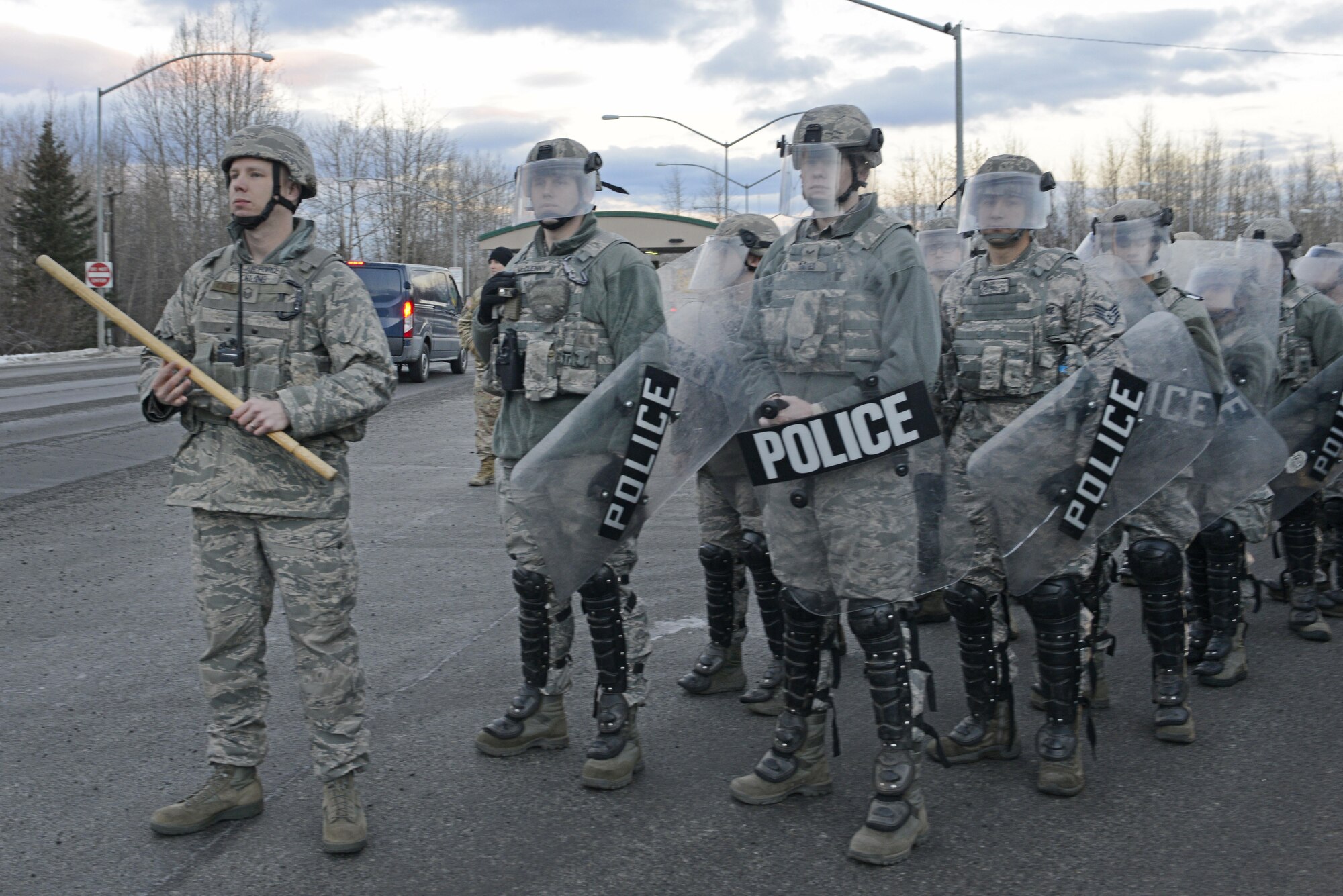 Joint Base Elmendorf-Richardson security forces personnel perform security operations during a simulated protest as part of exercise Polar Force 17-1 at JBER, Alaska, Nov. 1, 2016. The simulated protest began as a peaceful demonstration which escalated, resulting in a few aggressive protesters being detained and turned over to local law enforcement. The exercise tests the base's ability to integrate, mobilize, and prepare assigned personnel, aircraft and equipment for a wartime mission and to employ forces and weapons systems. 