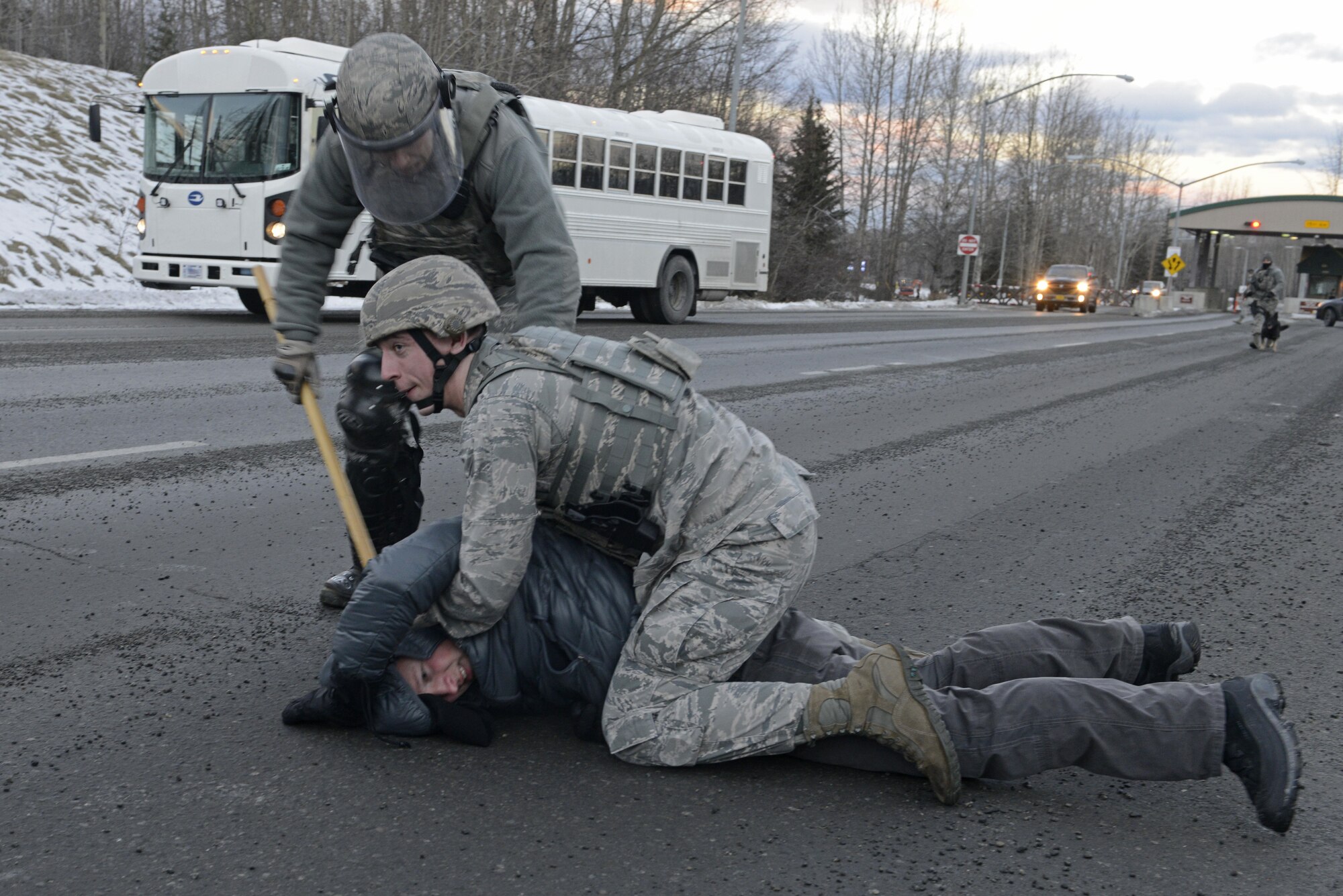 Joint Base Elmendorf-Richardson security forces personnel perform security operations during a simulated protest as part of exercise Polar Force 17-1 at JBER, Alaska, Nov. 1, 2016.The simulated protest began as a peaceful demonstration which escalated, resulting in a few aggressive protesters being detained and turned over to local law enforcement. The exercise tests the base's ability to integrate, mobilize, and prepare assigned personnel, aircraft and equipment for a wartime mission and to employ forces and weapons systems. 