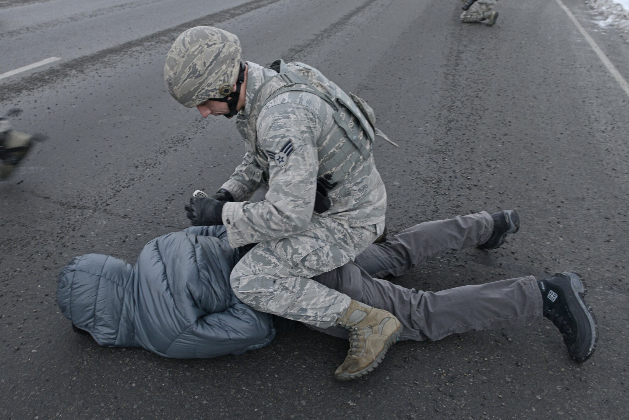 Joint Base Elmendorf-Richardson security forces personnel perform security operations during a simulated protest as part of exercise Polar Force 17-1 at JBER, Alaska, Nov. 1, 2016. The simulated protest began as a peaceful demonstration which escalated, resulting in a few aggressive protesters being detained and turned over to local law enforcement. The exercise tests the base's ability to integrate, mobilize, and prepare assigned personnel, aircraft and equipment for a wartime mission and to employ forces and weapons systems. 