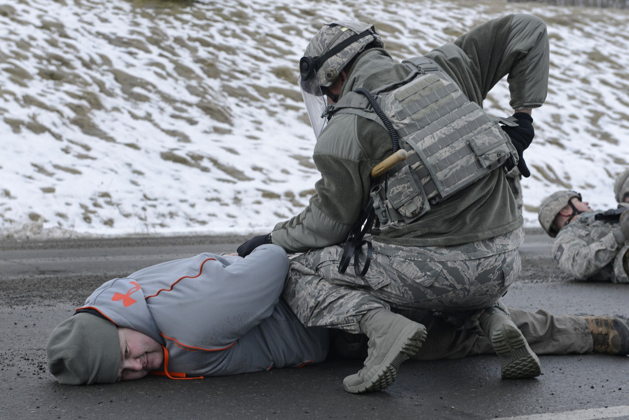 Joint Base Elmendorf-Richardson security forces personnel perform security operations during a simulated protest as part of exercise Polar Force 17-1 at JBER, Alaska, Nov. 1, 2016. The simulated protest began as a peaceful demonstration which escalated, resulting in a few aggressive protesters being detained and turned over to local law enforcement. The exercise tests the base's ability to integrate, mobilize, and prepare assigned personnel, aircraft and equipment for a wartime mission and to employ forces and weapons systems. 