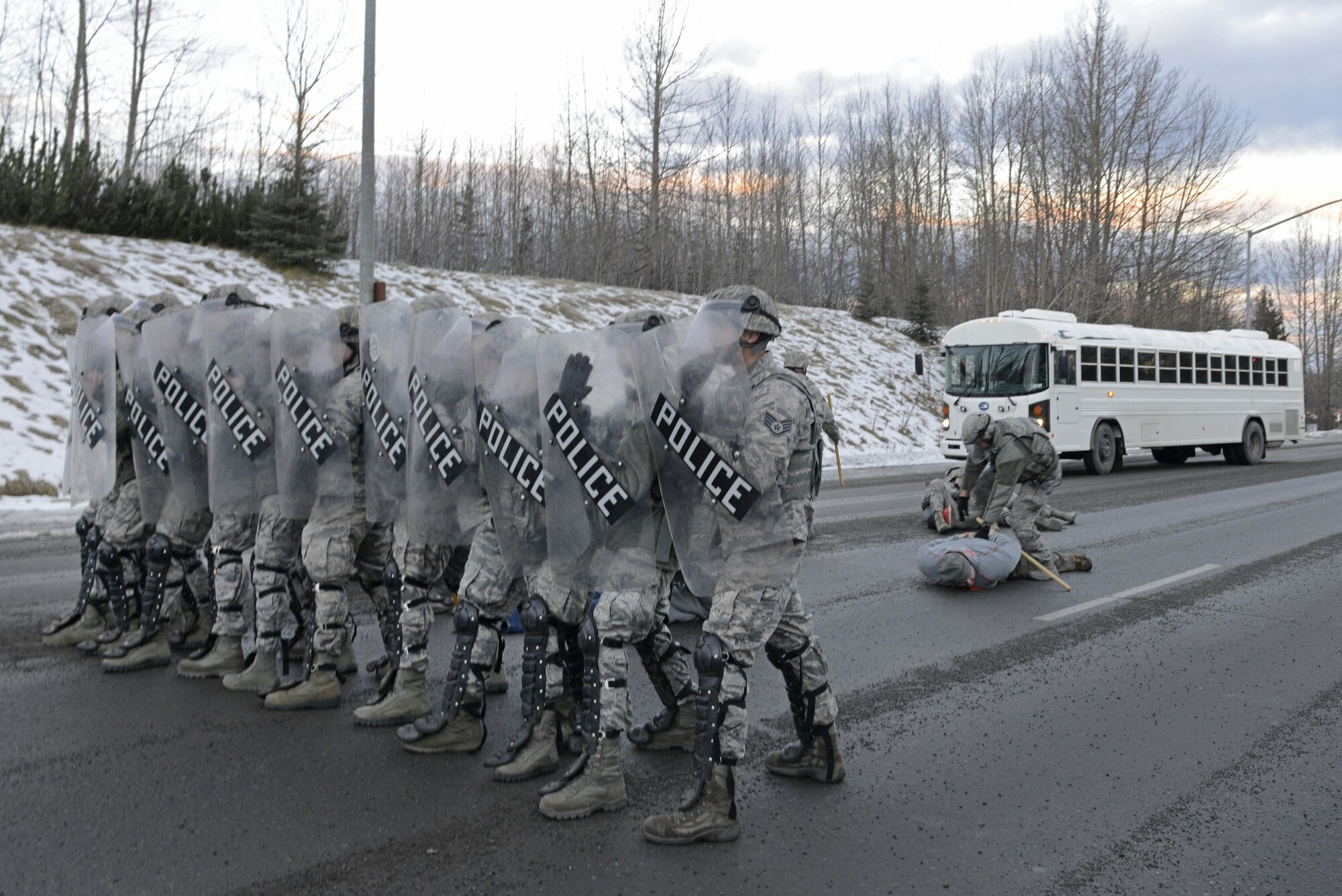 Joint Base Elmendorf-Richardson security forces personnel perform security operations during a simulated protest as part of exercise Polar Force 17-1 at JBER, Alaska, Nov. 1, 2016. The simulated protest began as a peaceful demonstration which escalated, resulting in a few aggressive protesters being detained and turned over to local law enforcement. The exercise tests the base's ability to integrate, mobilize, and prepare assigned personnel, aircraft and equipment for a wartime mission and to employ forces and weapons systems. 
