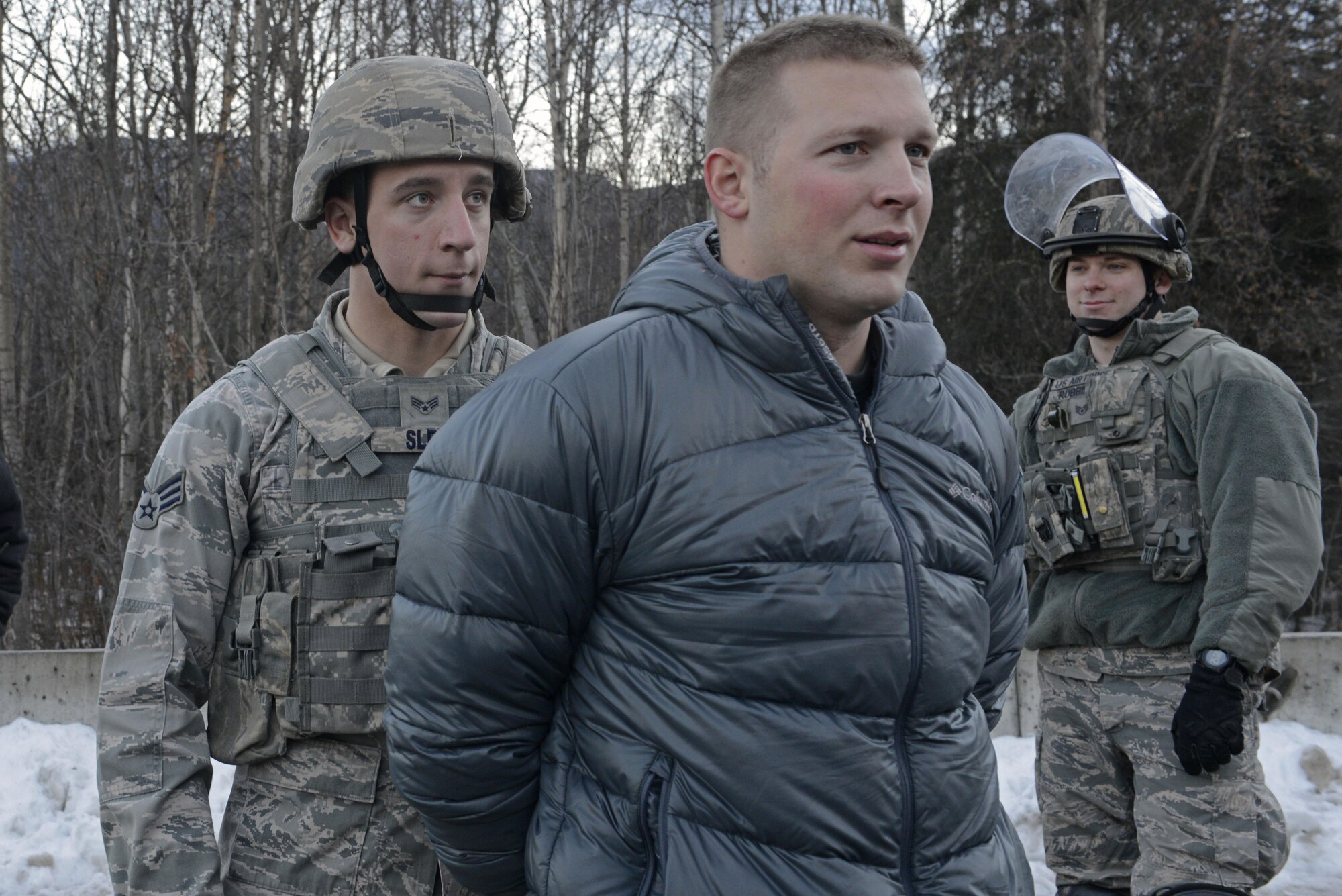 Joint Base Elmendorf-Richardson security forces personnel perform security operations during a simulated protest as part of exercise Polar Force 17-1 at JBER, Alaska, Nov. 1, 2016. The simulated protest began as a peaceful demonstration which escalated, resulting in a few aggressive protesters being detained and turned over to local law enforcement. The exercise tests the base's ability to integrate, mobilize, and prepare assigned personnel, aircraft and equipment for a wartime mission and to employ forces and weapons systems. 