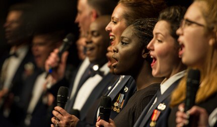 The U.S. Air Force Band Singing Sergeants sing “God Bless America” with a local high school choir during the U.S. Air Force Band Fall 2016 Tour in Pittsburgh, Oct. 28, 2016. In addition to the 14 vocalists that performed a collection of music ranging from opera to 1950s classics, the U.S. Air Force Band played a number of different musical pieces to inspire patriotism and military service. The tour lasted 10 days, beginning in Ohio and concluding in Pennsylvania. (U.S. Air Force photo by Senior Airman Jordyn Fetter)