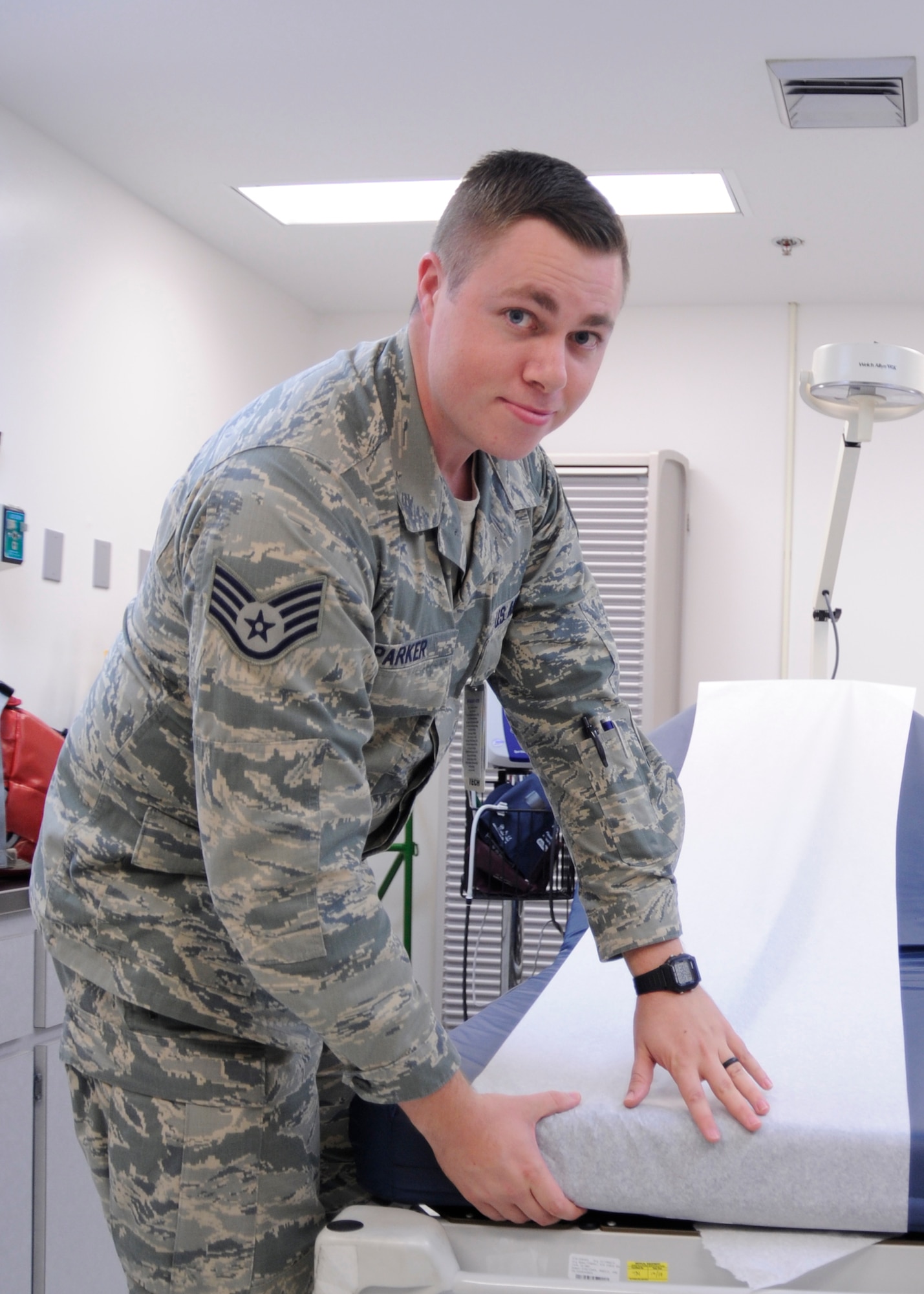 U.S. Air Force Staff Sgt. Jason Parker, 325th Aerospace Medical Squadron medical service craftsman, preps a waiting table for a patient in the Tyndall Air Force Base medical clinic, Fla., Oct. 25, 2016. Airmen like Parker handle the patient care and the administrative records of individuals who come to receive physical health assessments and other medical appointments at the 325th Medical Group. (U.S. Air Force photo by Senior Airman Solomon Cook/Released) 