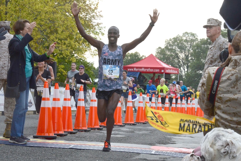 Army Spc. Samuel Kosgei takes first place at the 41st Marine Corps Marathon’s finish line near the Marine Corps War Memorial in Arlington, Va., Oct. 30, 2016. Kosgei’s winning time was two hours, 23 minutes and 53 seconds, Army photo by David Vergun