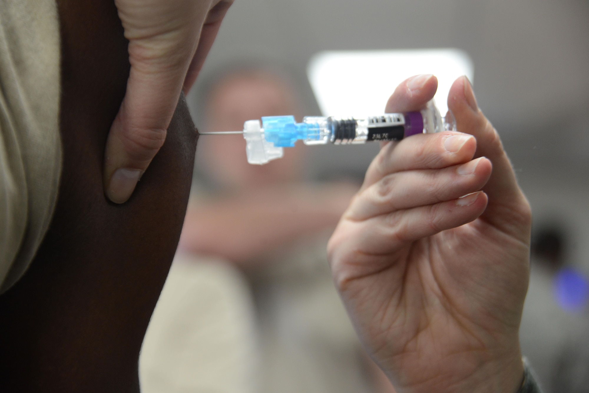 Senior Airman Casie Neiman, 673d Medical Operational Support Allergy and Immunizations backup technician, delivers a flu vaccine to a patient at the People Center at Joint Base Elmendorf-Richardson, Alaska, Oct. 5, 2016. Patients receive the full benefits of the vaccine after two weeks; protection lasts for a few months. The Allergy and Immunization clinic recommends taking the influenza shot mid-October for maximum protection against the expected flu spike between January and April. 