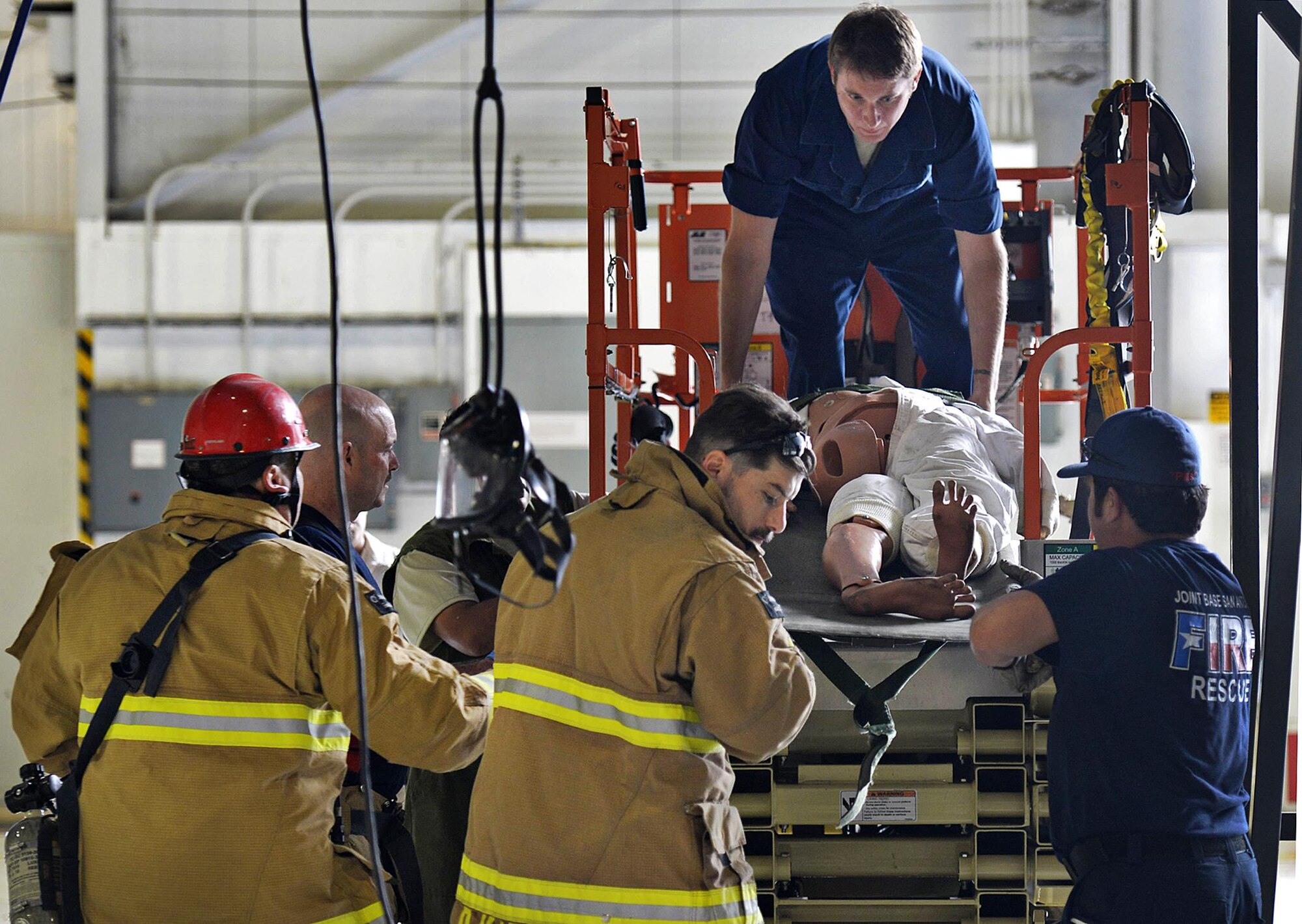 Tech. Sgt. David Ragsdale, 433rd Maintenance Squadron fuel systems technician, helps evacuate a manikin from the fuel tank of a C-5M Super Galaxy aircraft during a fuel extraction exercise Nov. 1, 2016 at Joint Base San Antonio-Lackland, Texas. Fireman with the 502nd Civil Engineering Squadron assisted in the extraction by safely securing the patient from the fuel tank and providing basic life support.  (U.S. Air Force photo by Benjamin Faske)