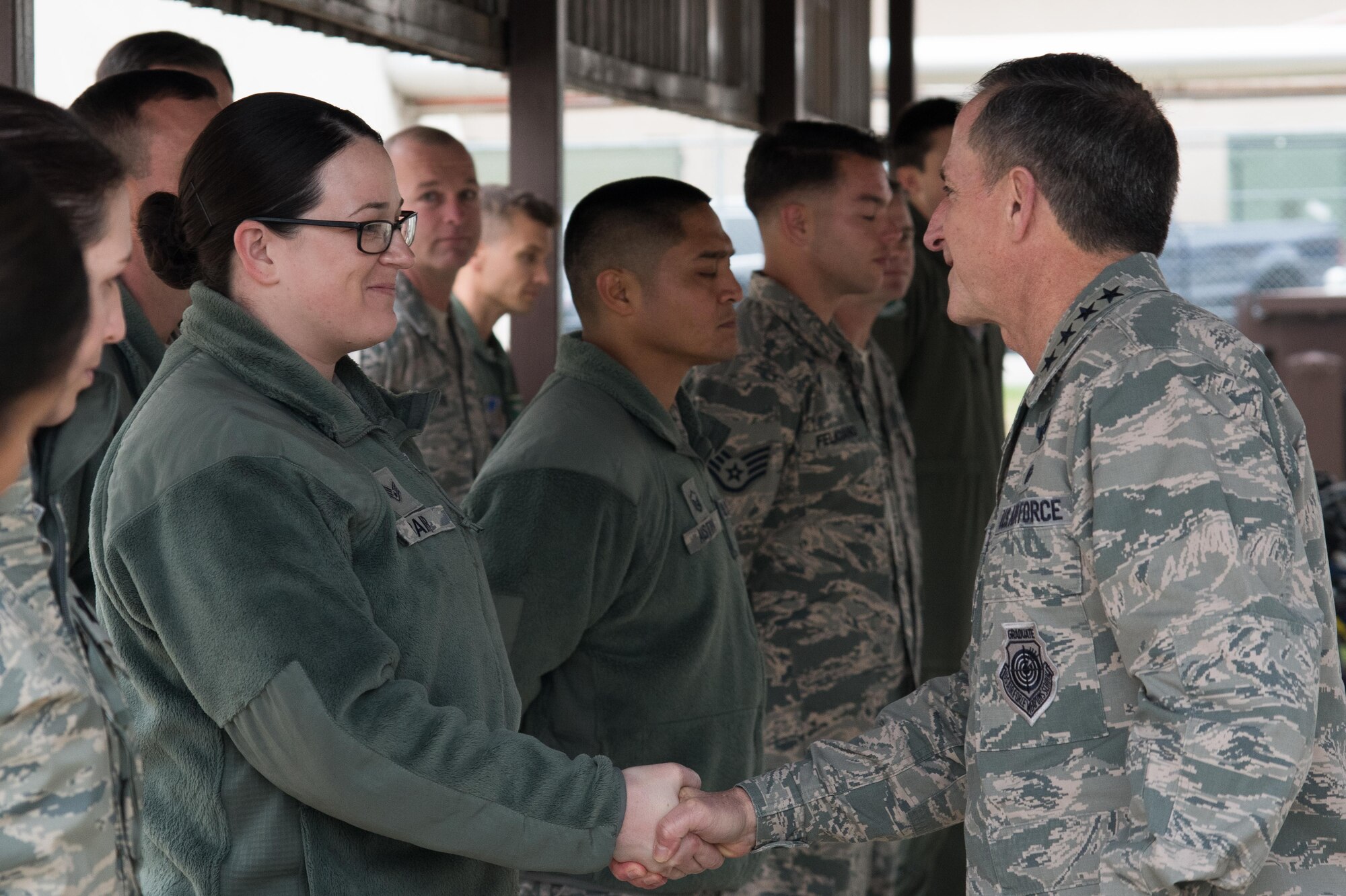 U.S. Air Force Staff Sgt. Christina Bair, 51st Fighter Wing weapons safety manager, receives a coin from Air Force Chief of Staff David L. Goldfein during a coining ceremony at Osan Air Base, Republic of Korea, Oct. 31, 2016. Goldfein rewarded high-performance Osan Airmen with his coin for their part in executing the 51st Fighter Wing mission. (U.S. Air Force photo by Senior Airman Dillian Bamman)