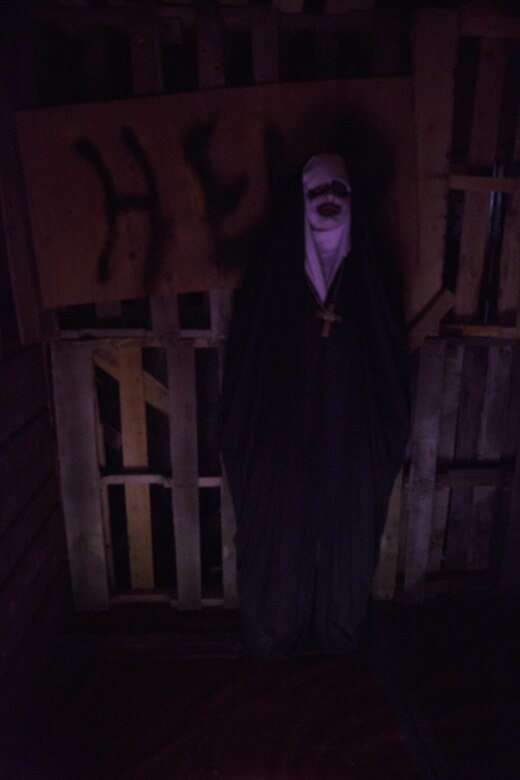 An actor dressed as Valak, a demon from the movie, “The Conjuring 2,” haunts a corner of the Okinawa Haunted Labyrinth Oct. 29 on Marine Corps Air Station Futenma, Okinawa, Japan. Volunteers with the Single Marine Program hosted the open-gate event to strengthen the relationship between Okinawa residents and Status of Forces Agreement members with a frightfully fun haunted house experience. SMP volunteers designed, built and decorated the labyrinth in approximately four weeks. Once the maze was constructed, volunteers designed chilling costumes and staffed grisly scenes for guests who braved the haunted course.
