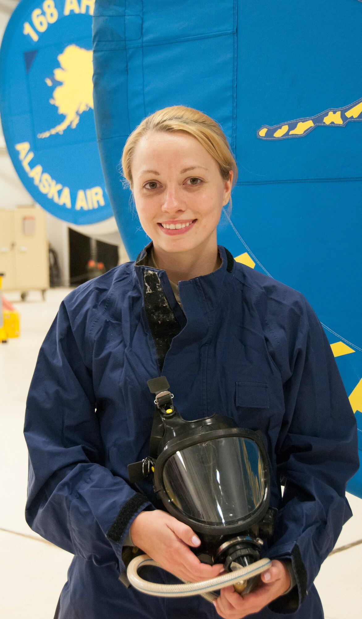 Staff Sgt. Julia Meyer, a fuels systems mechanic with the 168th Maintenance Squadron, holds her respirator while dressed in waterproof overalls inside the unit's fuel cell at Eielson AFB, Alaska, October 18, 2016. Meyer is a fulltime technician with the Interior-Alaska unit and was recognized for her outstanding technical abilities during a recent deployment to Southwest Asia. (U.S. Air National Guard photo by Senior Master Sgt. Paul Mann/Released)