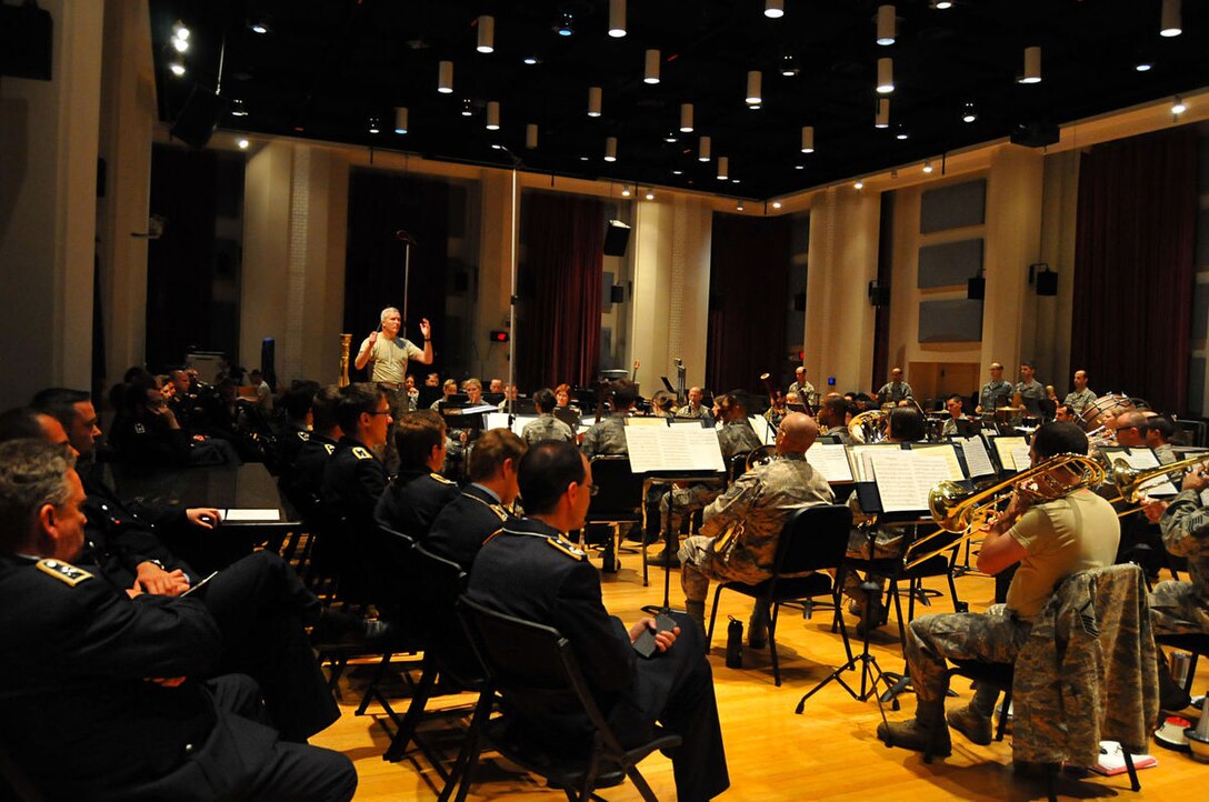 The German Air Force Band watches as the United States Air Force Concert Band practices for their upcoming shows, Sept. 28 at the USAF Band hangar. The German AF Band toured the hangar and were greeted by short performances from the Singing Sergeants, the Air Force Strings, Max Impact, and the Concert Band.