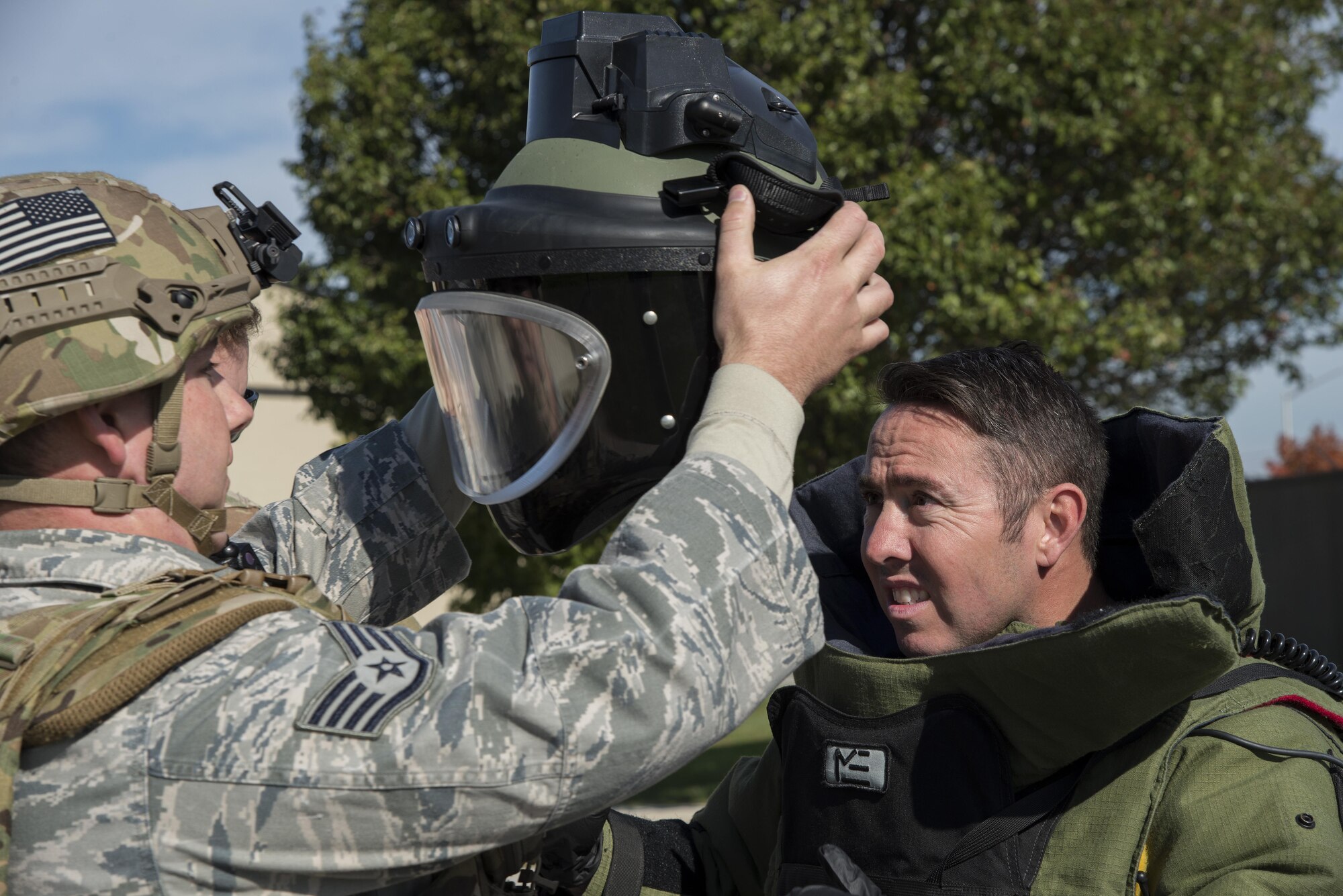 Staff Sgt. William Spencer prepares Staff Sgt. J. J. Hargrove, both 436th Civil Engineer Squadron explosive ordnance disposal journeymen, Oct. 26, 2016, at the south gate on Dover Air Force Base, Del. Hargrove was preparing to approach a simulated suspected vehicle-borne radiological device during an annual force protection and major accident response exercise. (U.S. Air Force photo by Senior Airman Aaron J. Jenne)